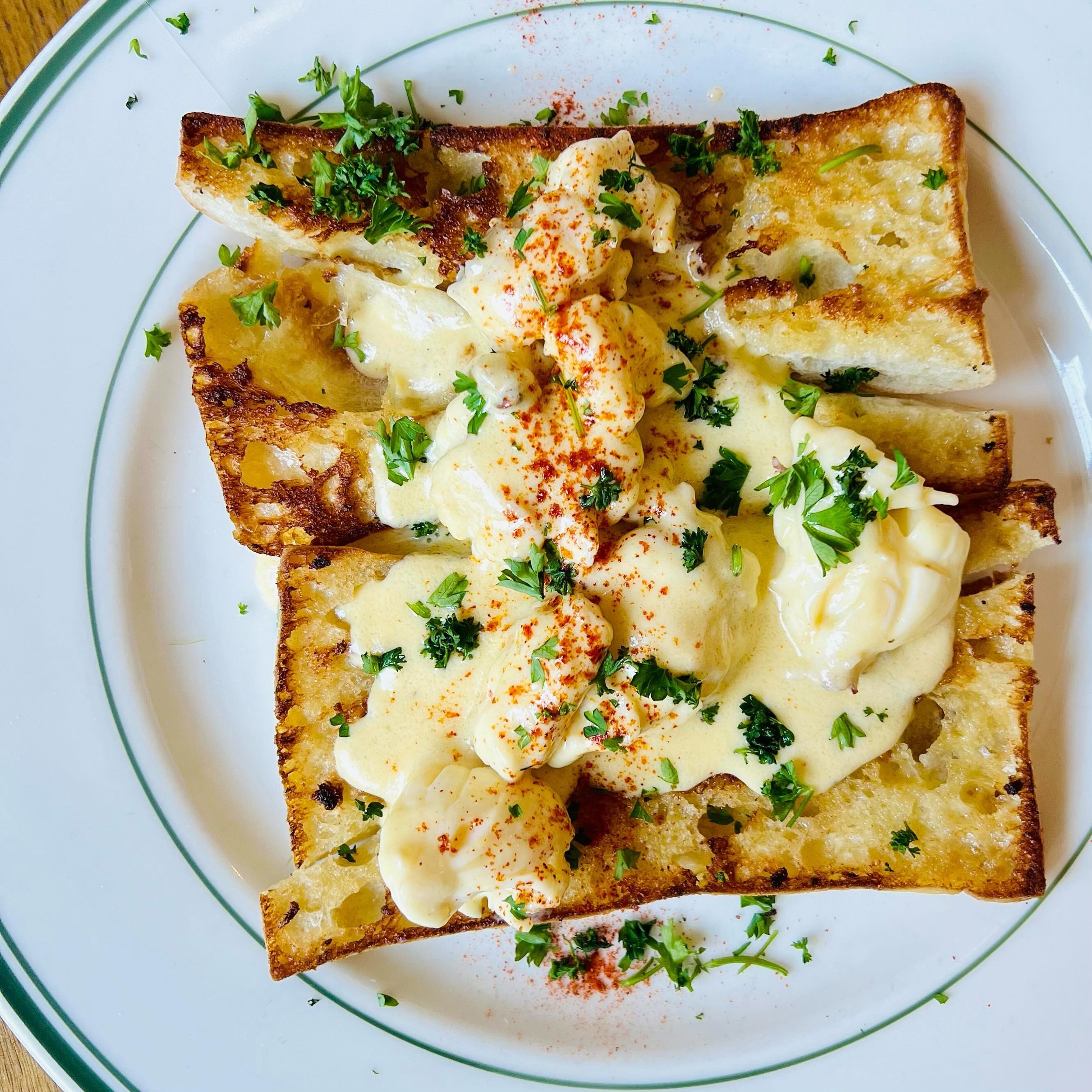 LOBSTER TOAST
Reimagines the classic Lobster Newburg, featuring succulent lobster saut&eacute;ed in butter and sherry. The lobster is then gently simmered in a luxuriously rich sauce made from egg yolks and cream. Served atop slices of crispy ciabatt