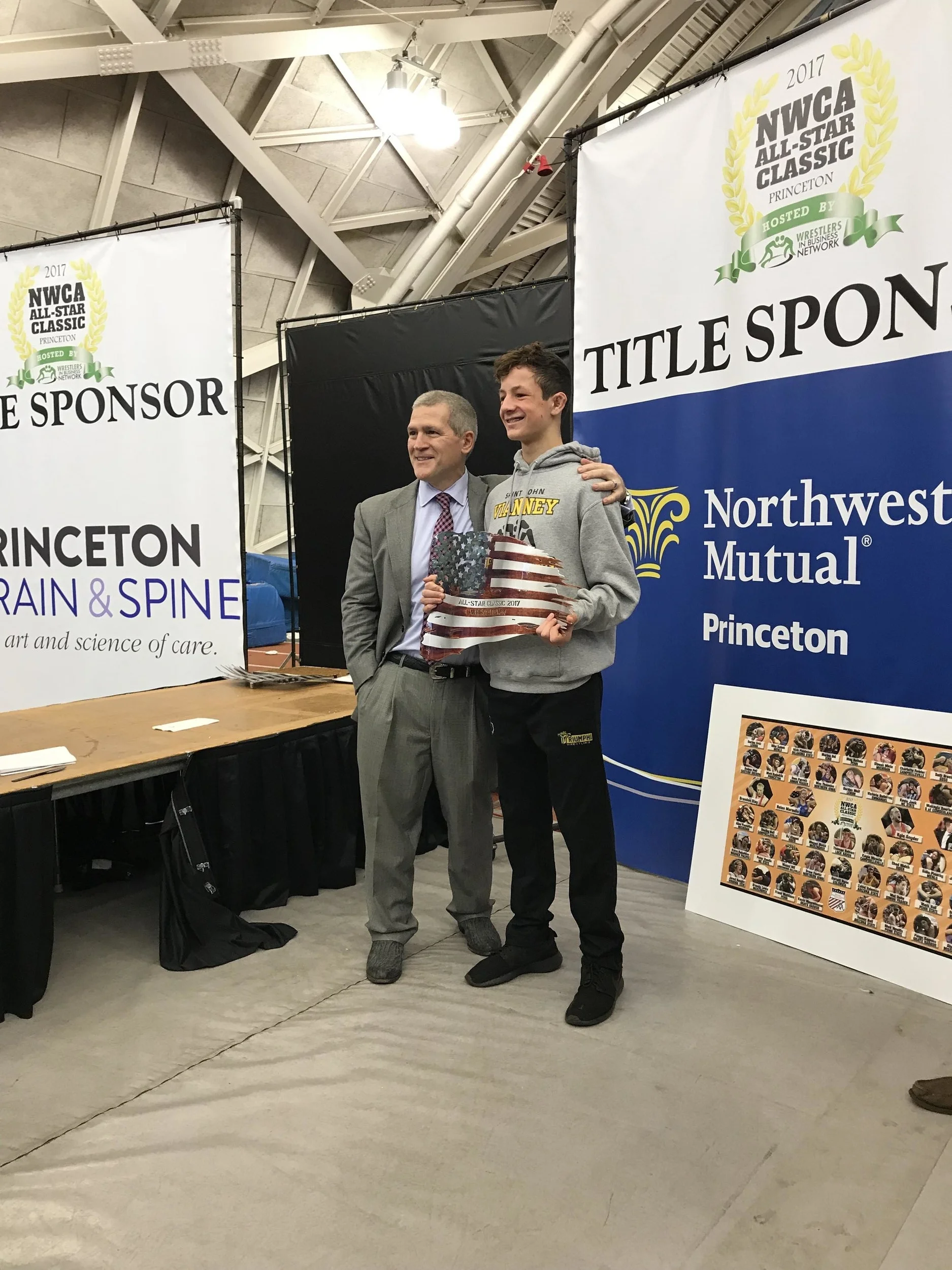 WIMS founder, Joe Butler, with Dr. Mark McLaughlin receiving the "Wrestle Back" award at the 2017 NWCA All-Star classic presented by the Wrestlers in Business Network. 