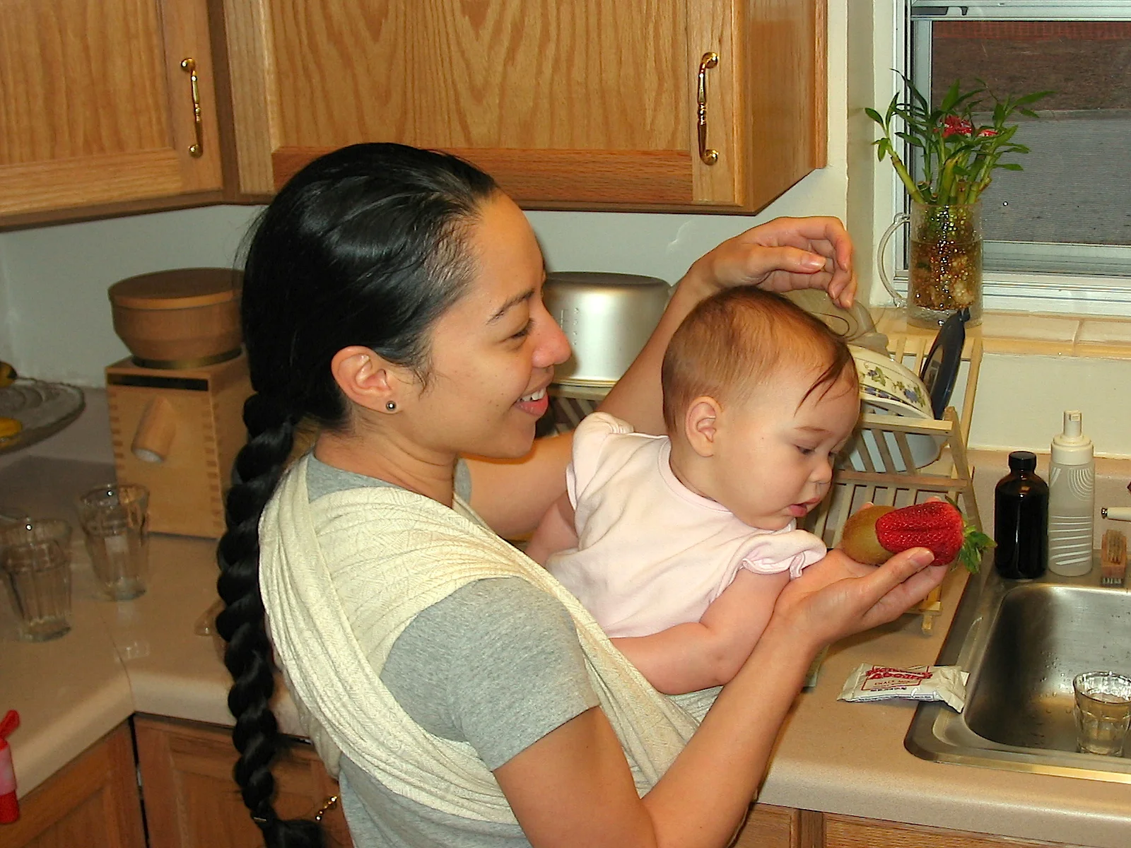 Franicia with one of our children in 2004. If you purchase Franicia's latest book, I Know You Love Me, Mommy and Daddy, you will see this image rendered in watercolor.