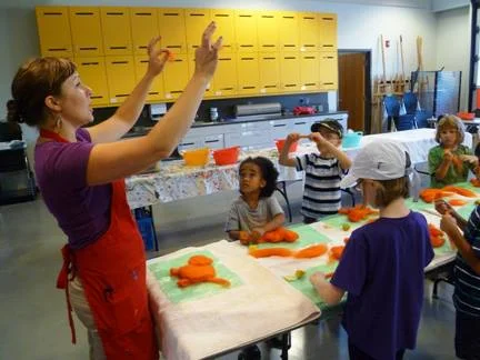 Renée teaching the kids how to layer the wool to create a wet-felted tiger!