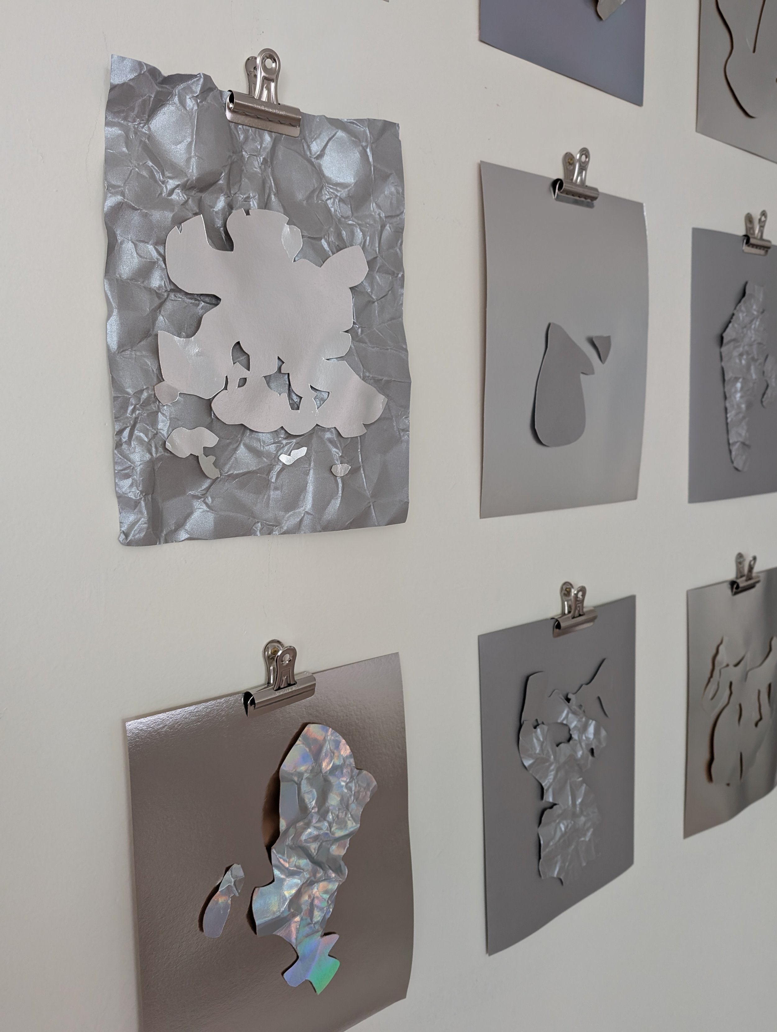 Ice Series installation , detail, hand-cut paper, bull dog clips, nails, 48”x56,” 2025