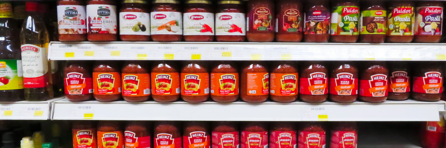 jars of bright red tomato sauce line the shelves of an Egyptian supermarket