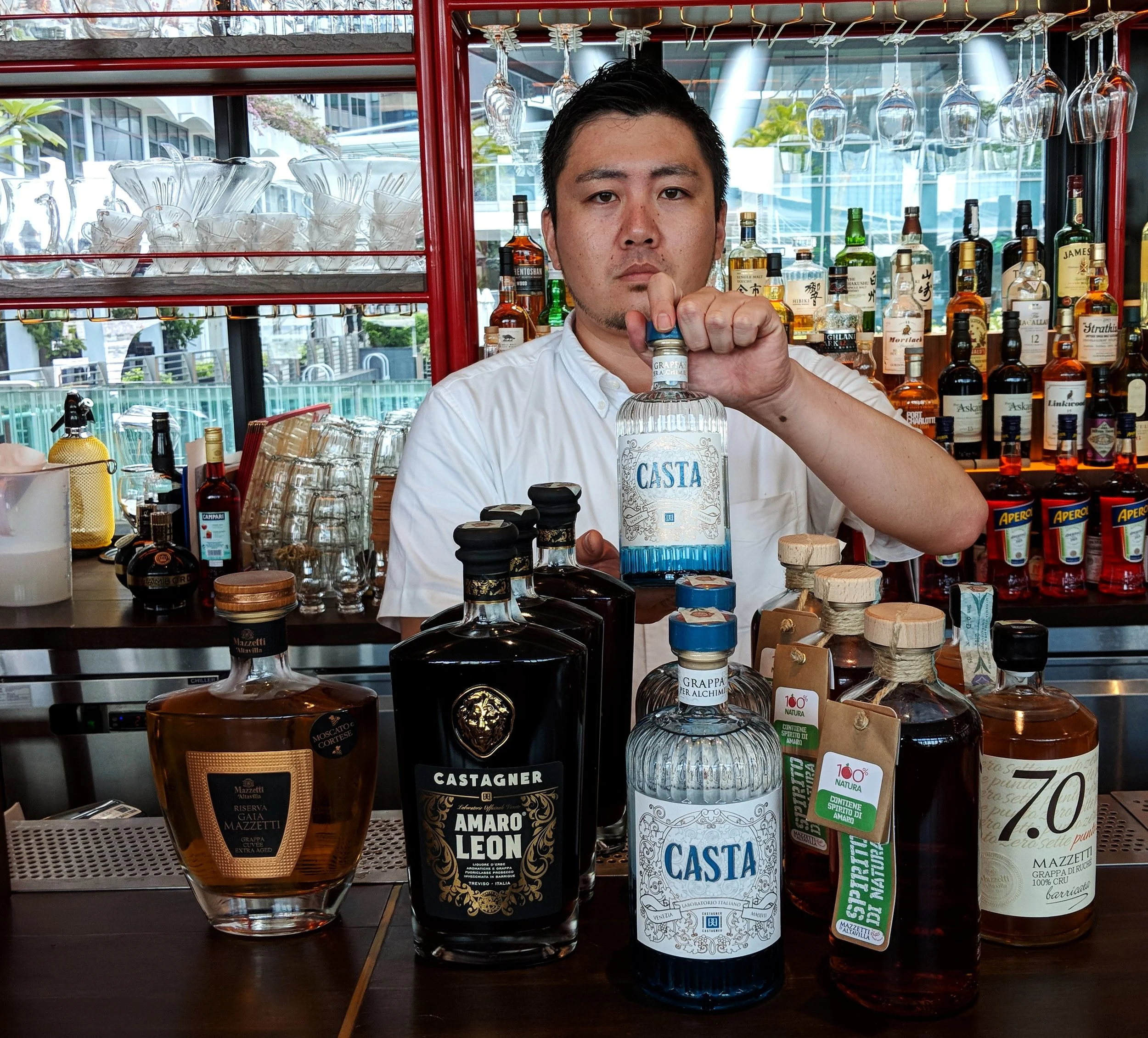 Aki of Caffe Fernet showing of Castagner and Mazzetti grappe and amari