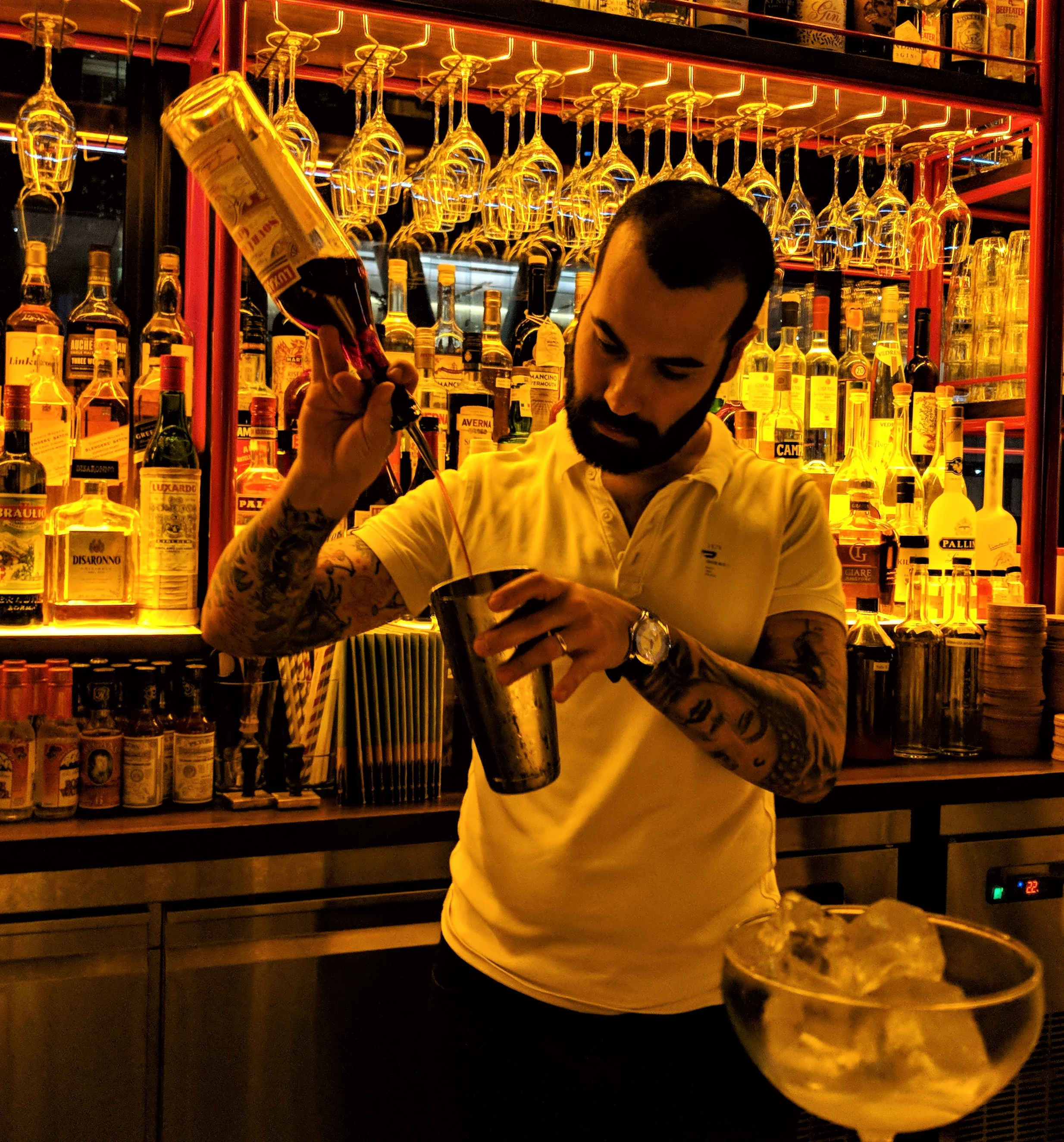 Diego pours Luxardo Sour cherry gin for a Negroni