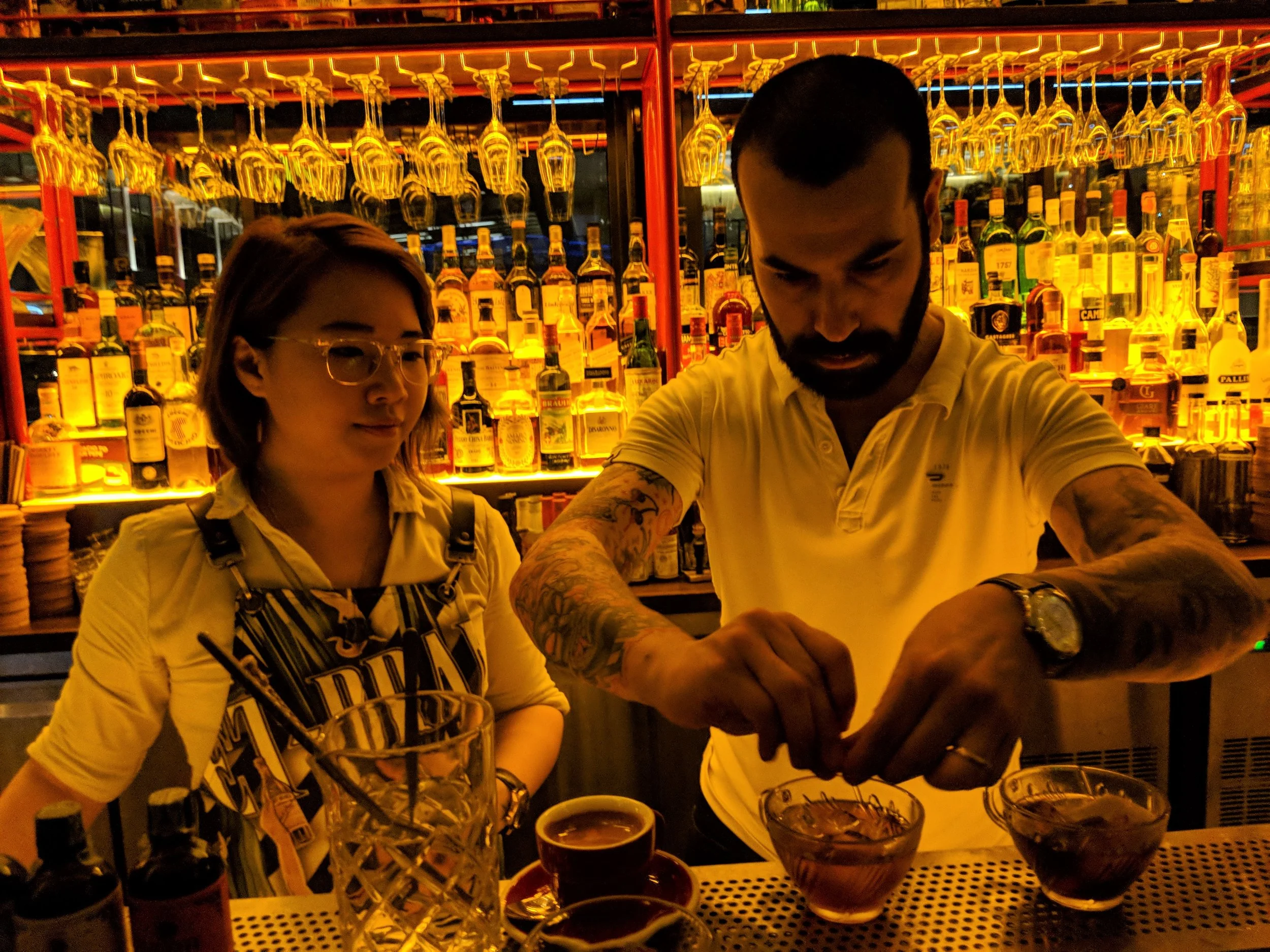 Cherrie of Caffe Fernet studies the guest bartender Diego Ferrari