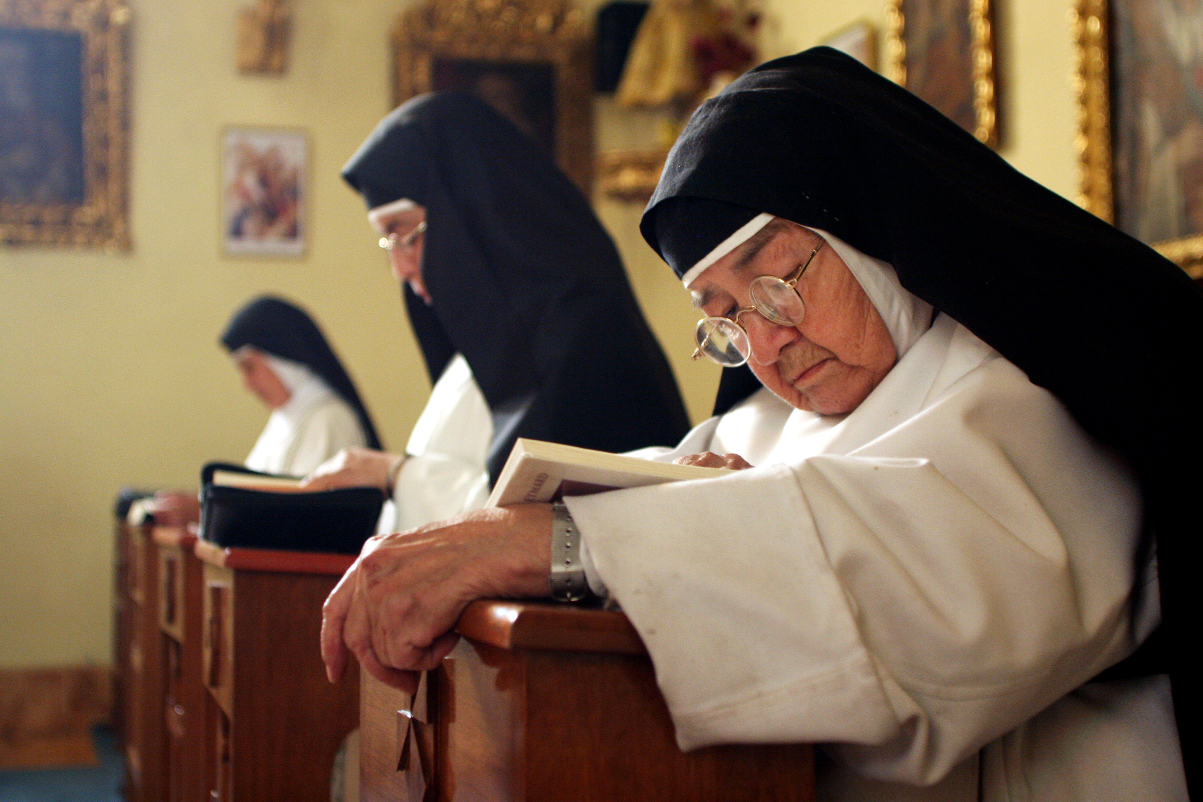  Sister Consuelo de Jesus concentrates on her Bible study, or Lexio Divino, during silent prayer in Santa Catalina Monastery's chapel. The nuns gather five times a day for prayer, the methods of which vary from singing, to chanting, to reciting the r