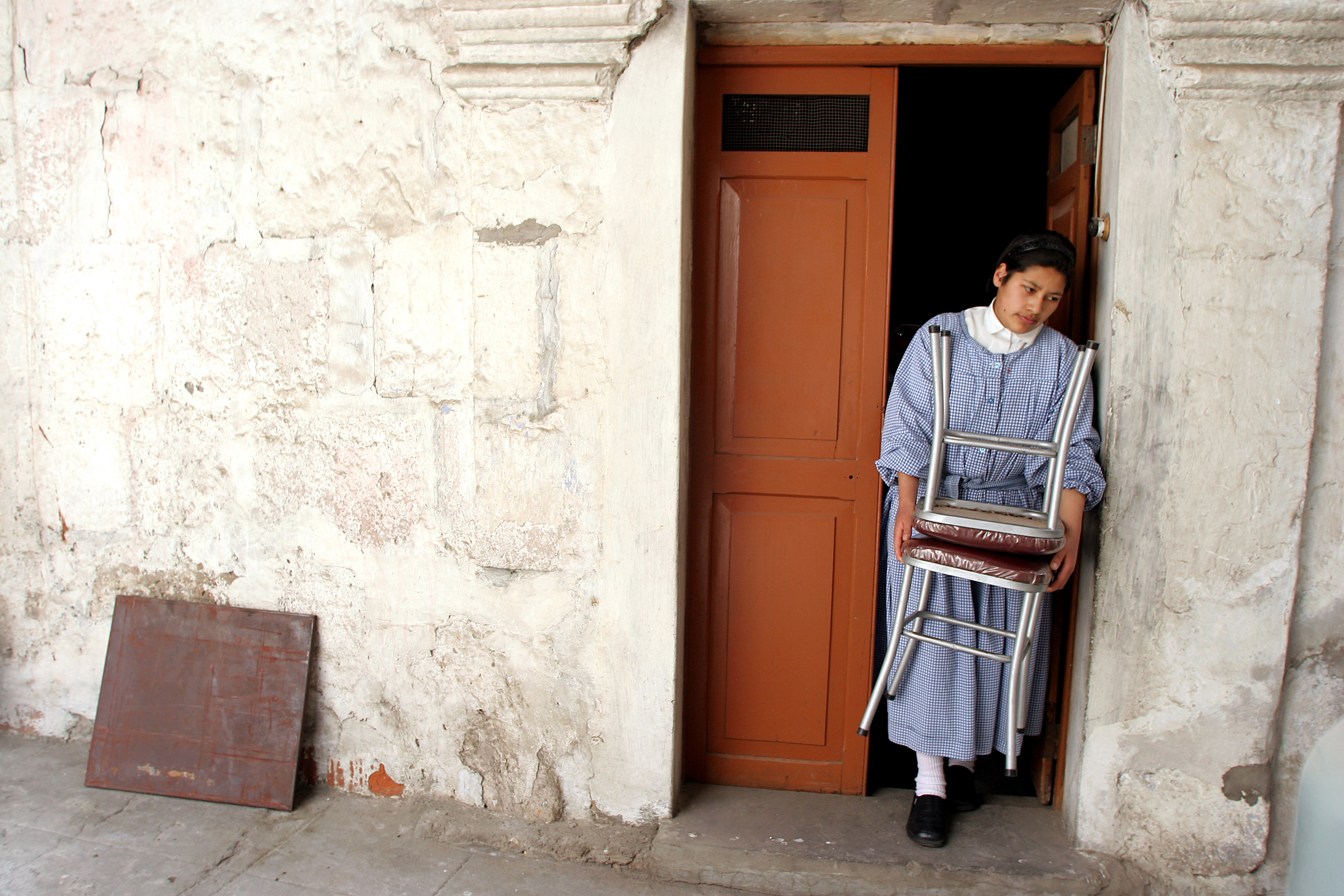  Sister Heidi carries chairs from a storage area to a larger room where all the women can sit together to make soap. The nuns consider Santa Catalina a community within itself; in an effort to replicate the fact that outsiders must work for a living,