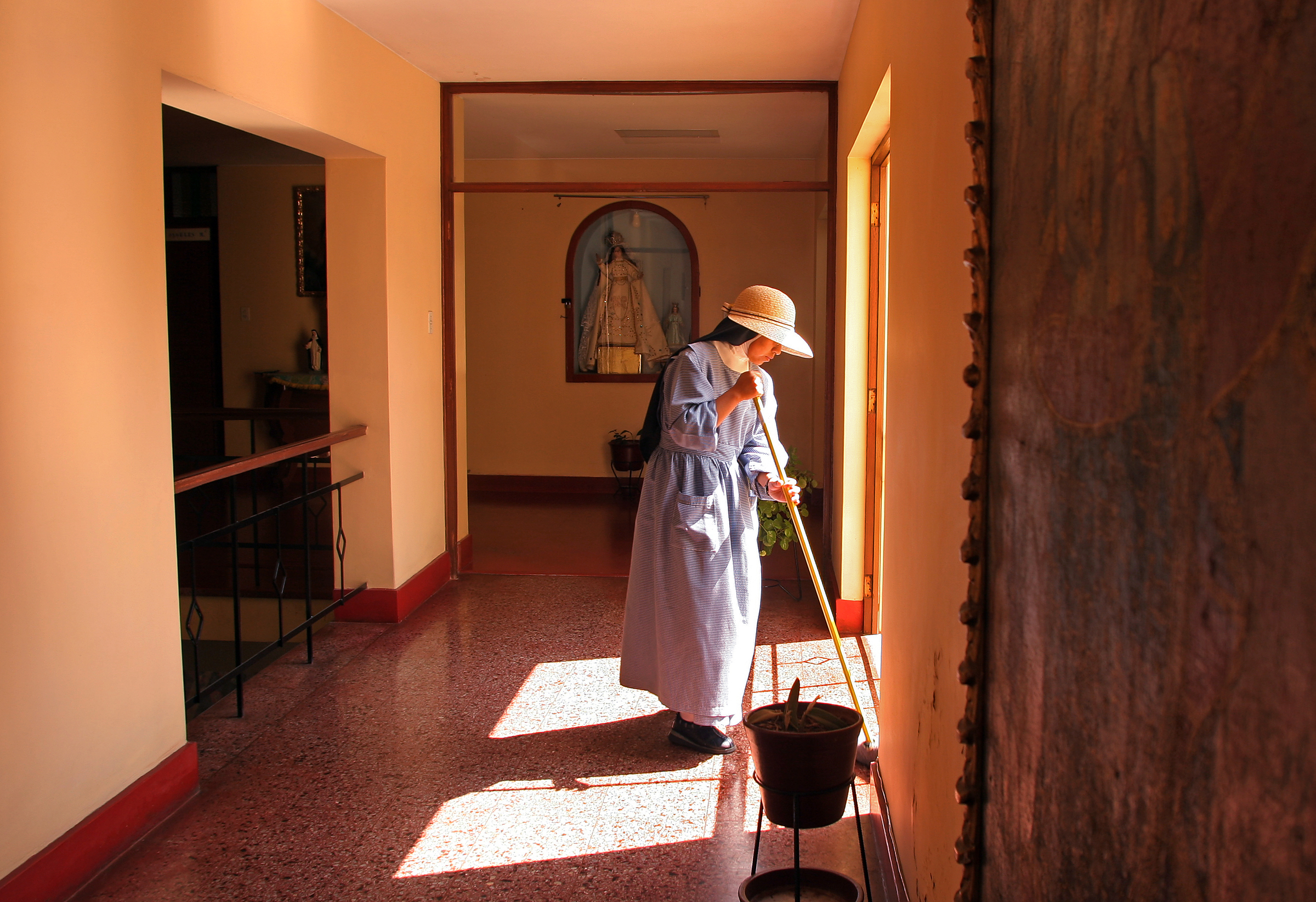  A nun mops the floor in the dormitory area of the monastery. 