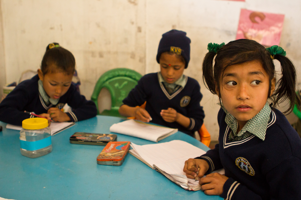  She's the First Scholar and first grader Pushpa R., right, copies from the board in class in Nepal, March 2015. (photo by Kate Lord) 