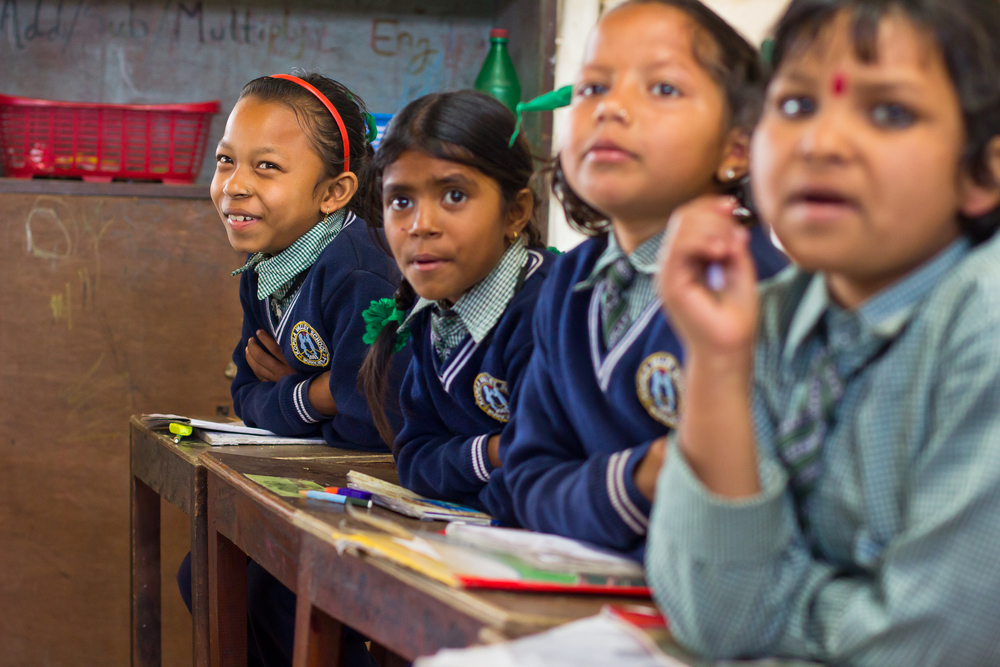  She's the First Scholar Robina C., far left, sings along in her second grade class in Nepal, March 2015. (photo by Kate Lord) 