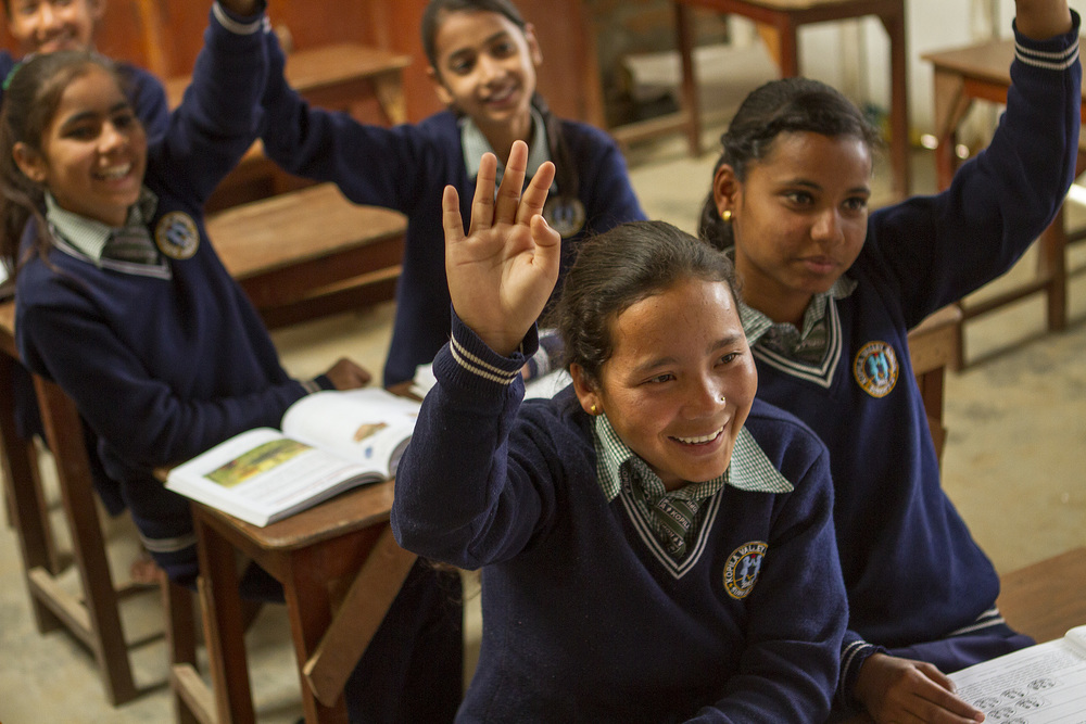  She's the First Scholar and tenth grader Roshni S. raises her hand in school in Nepal, March 2015. (photo by Kate Lord) 