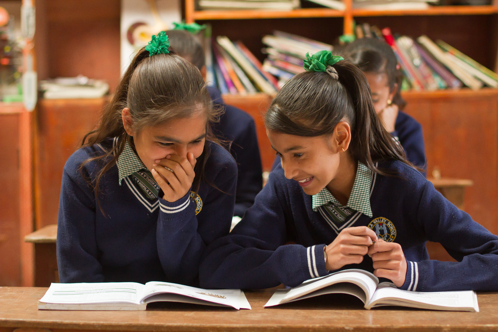  She's the First Scholars Sarita A. and Apeksha K. chat in their school's science classroom in Nepal, March 2015. (photo by Kate Lord) 