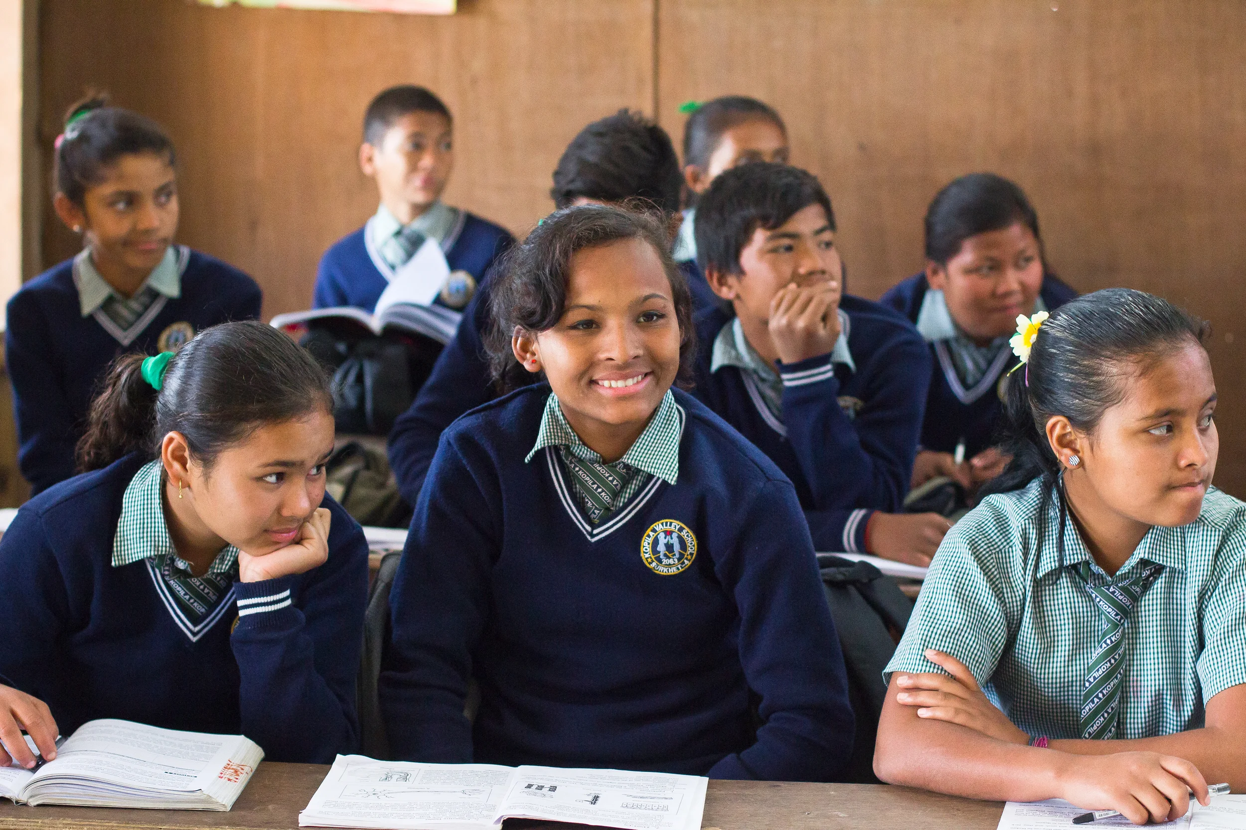  Sirjana, center, listens during her eighth grade class. 