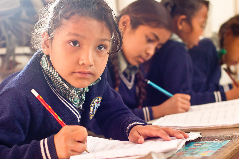  She's the First Scholar Sarita S. concentrates on her lesson in her third grade class in Nepal, March 2015. (photo by Kate Lord) 