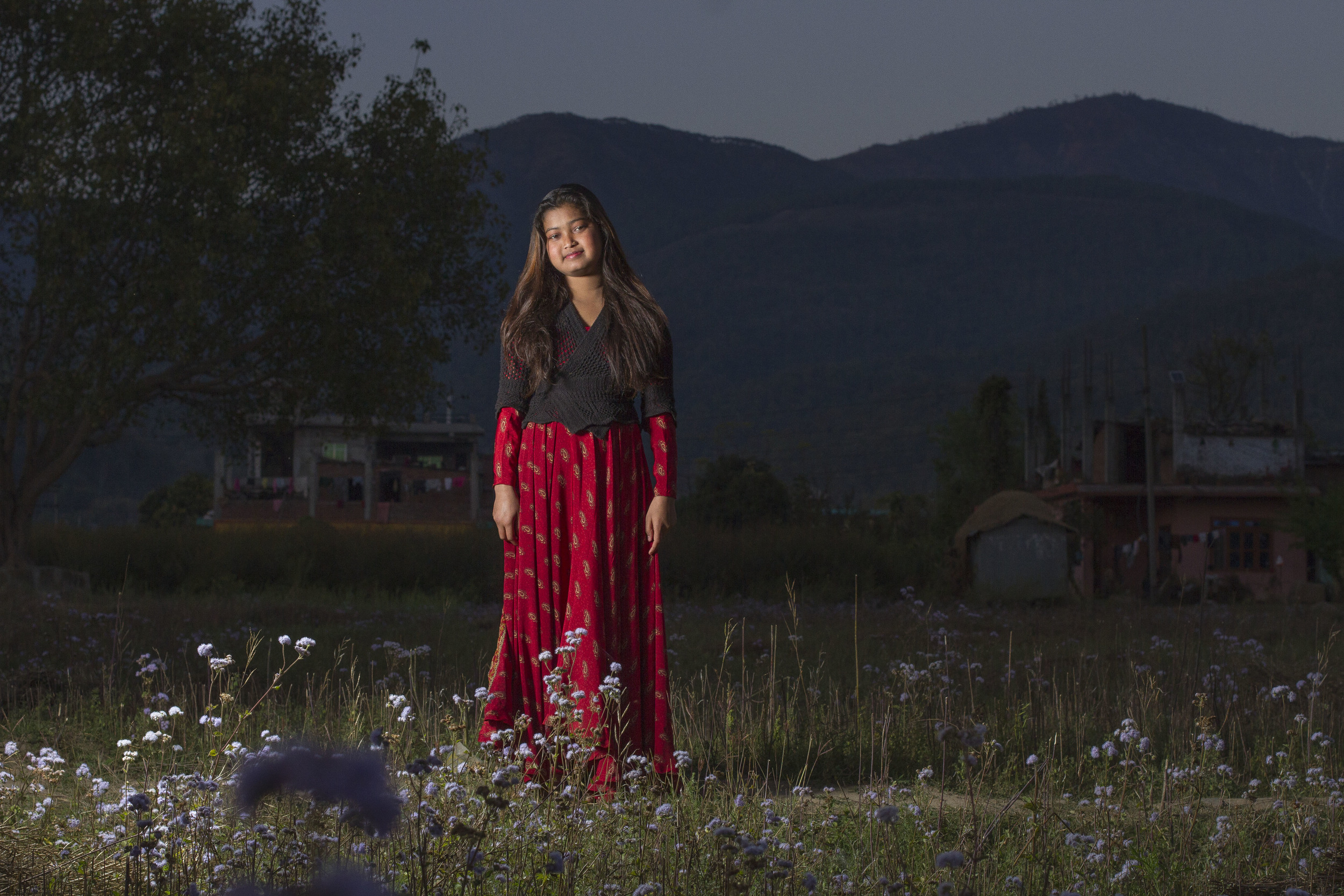  She's the First Scholar and poet Deepa N. poses in a field near her school in Nepal, March 2015. (photo by Kate Lord) 
