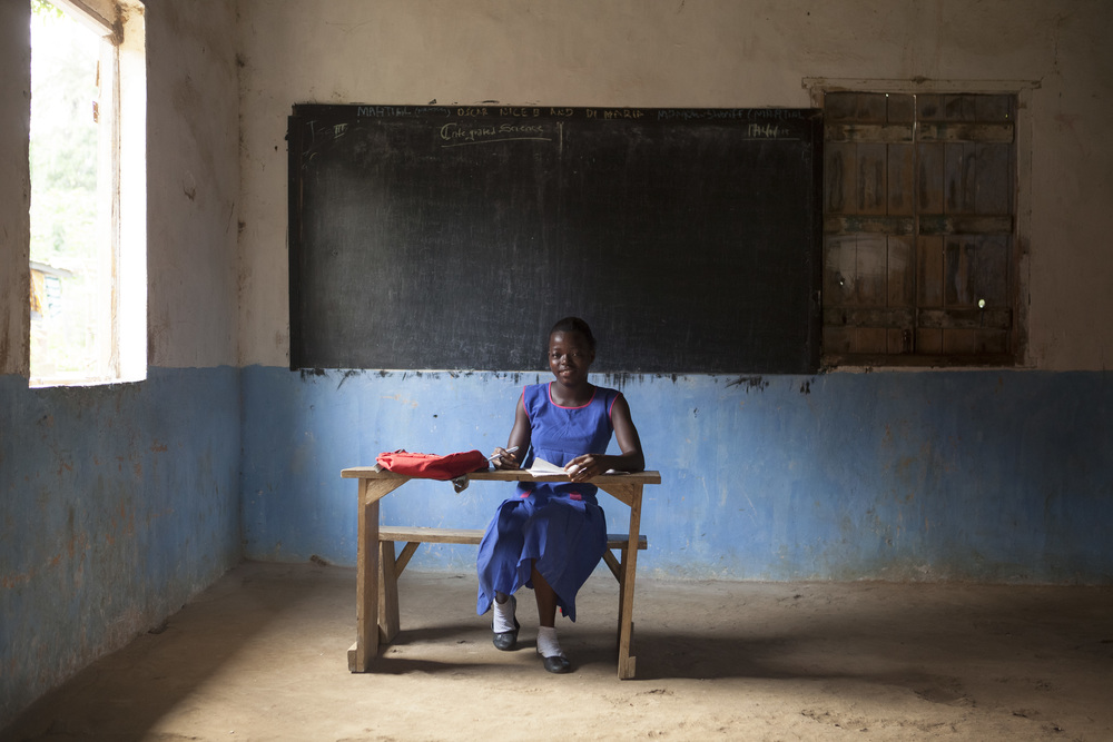  Yeanoh, 15, poses in her classroom. She loves reading, singing, and dancing. 