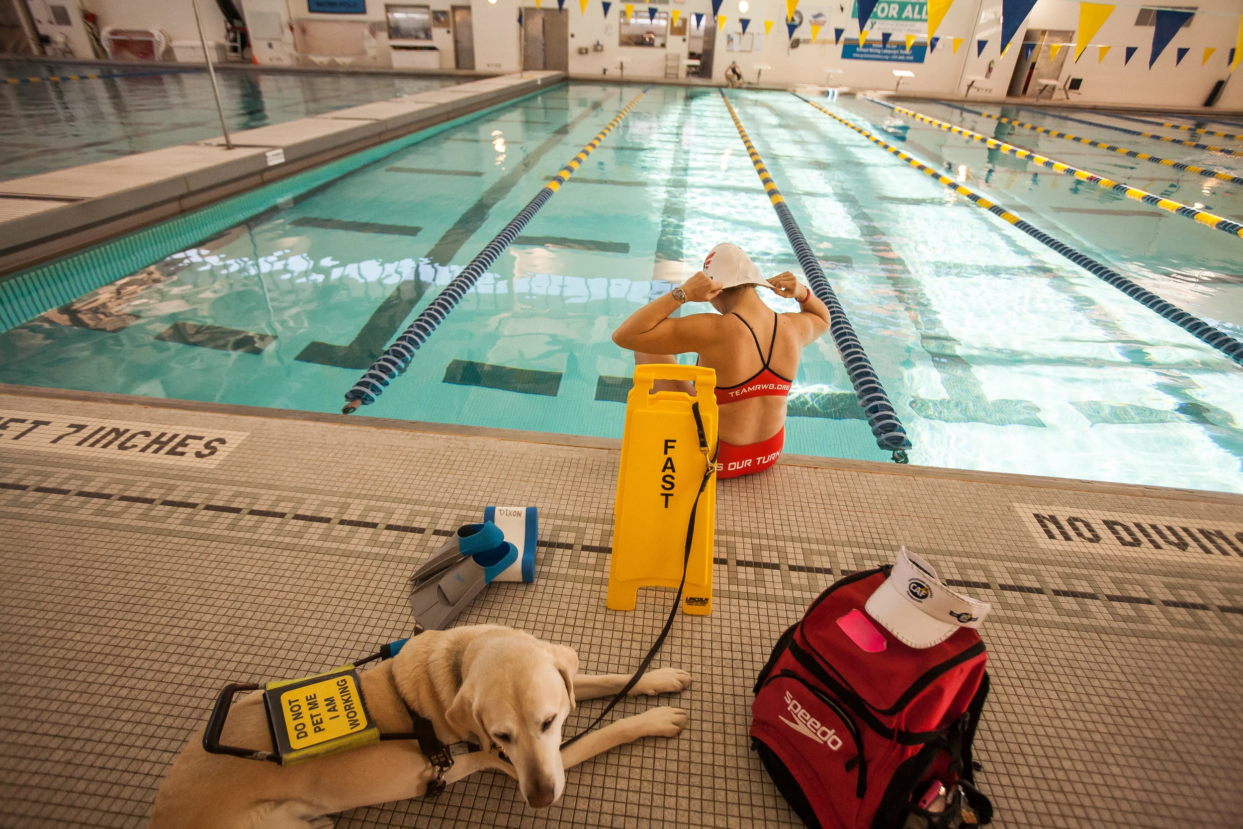  Amy Dixon, a visually impaired sommelier and triathlete, puts on her swim cap before a light swim workout at the YMCA at Greenwich in Greenwich, Connecticut, Thursday, Dec. 12, 2013. Dixon is training for several championship competitions next year,