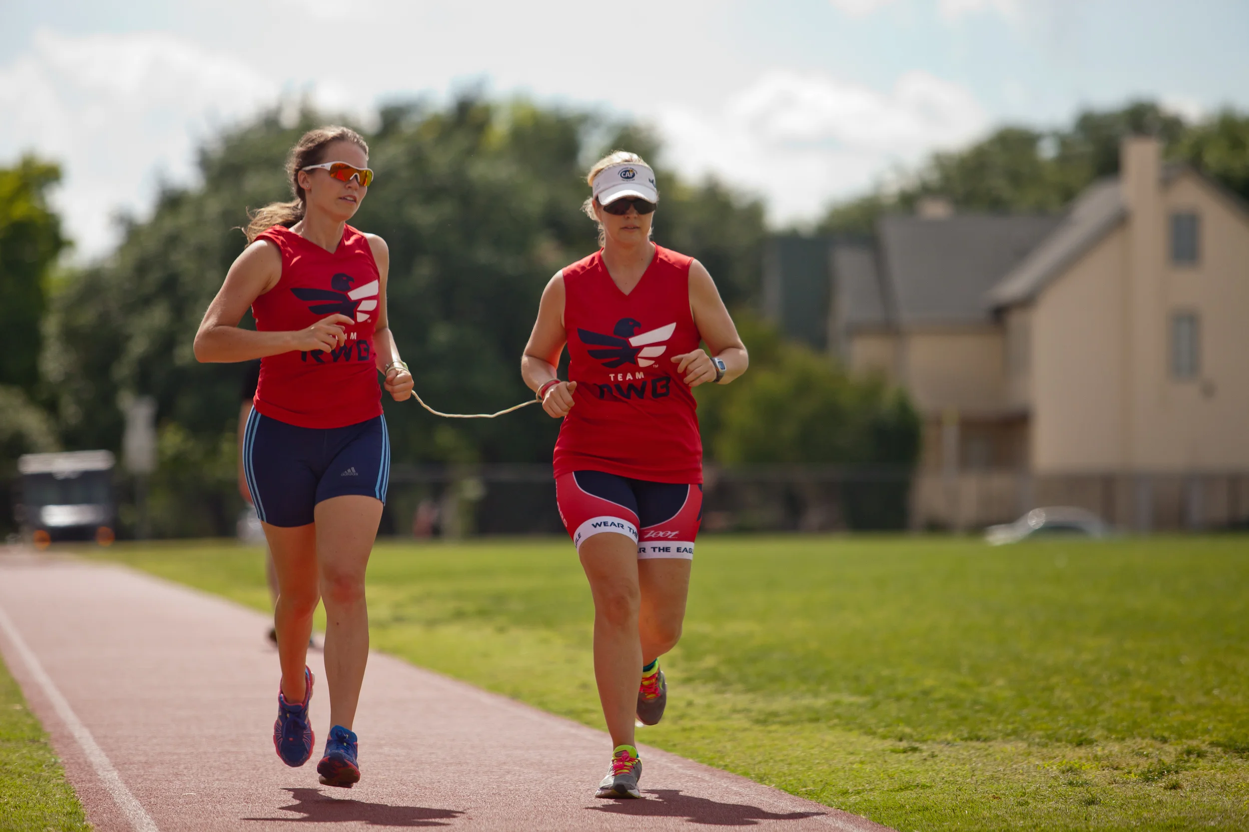  Amy Dixon (right), a visually impaired sommelier and triathlete, and her guide Caroline Gaynor, co-triathlon director at Team Red, White & Blue, go on a training run before the 2014 Dallas Panamerican Triathlon Confederation (PATCO) Triathlon Pan Am