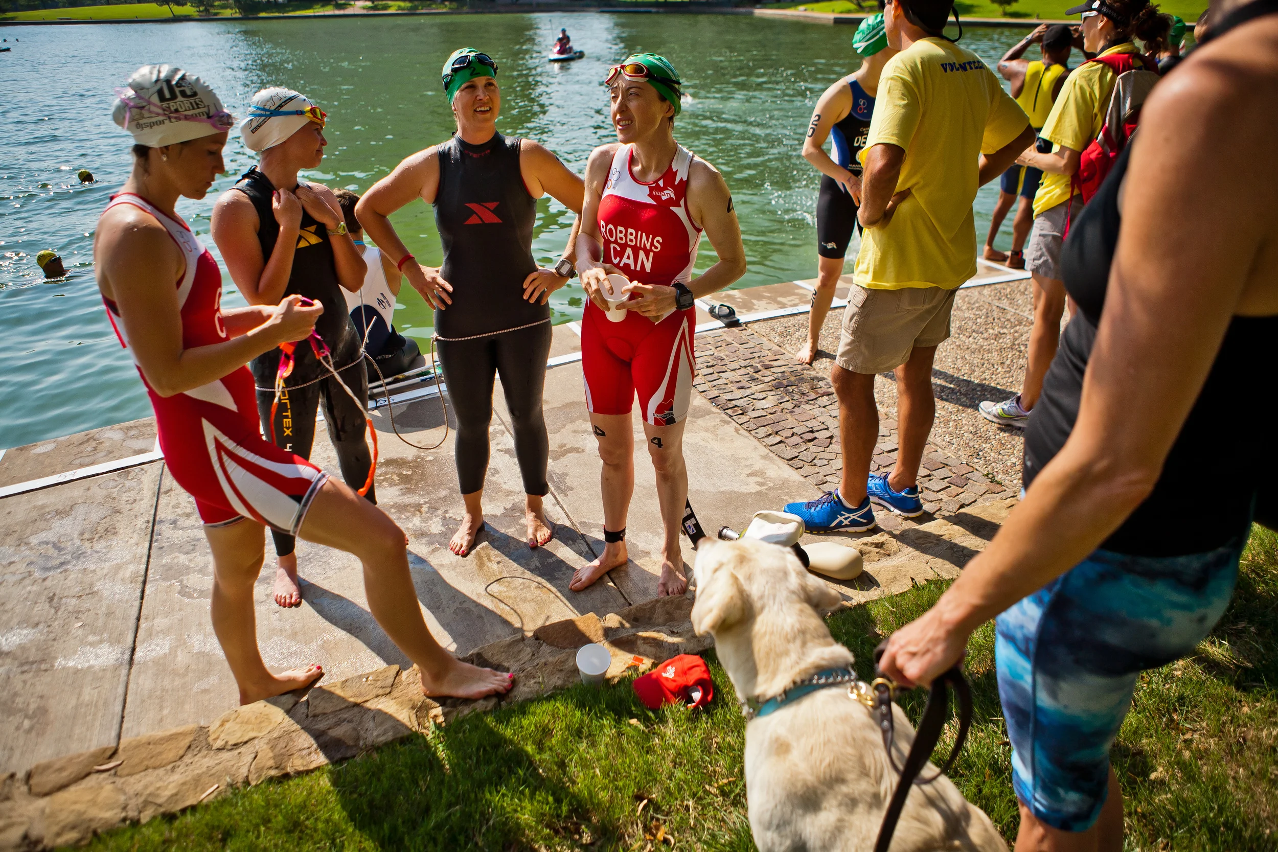  Amy Dixon (center, in green cap), a visually impaired sommelier and triathlete, chats with other parathletes and  guides at the 2014 Dallas Panamerican Triathlon Confederation (PATCO) Triathlon Pan American Championships on June 1, 2014 at the Marri