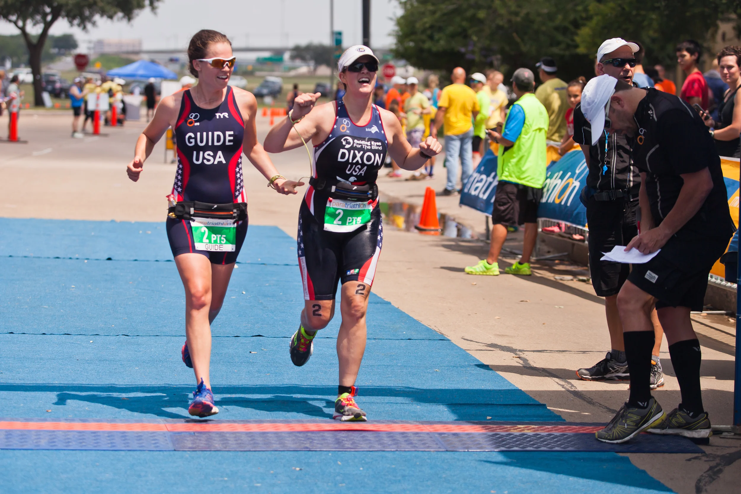  Amy Dixon (right), a visually impaired sommelier and triathlete, crosses the finish line of the 2014 Dallas Panamerican Triathlon Confederation (PATCO) Triathlon Pan American Championships with her guide Caroline Gaynor (left), co-triathlon director