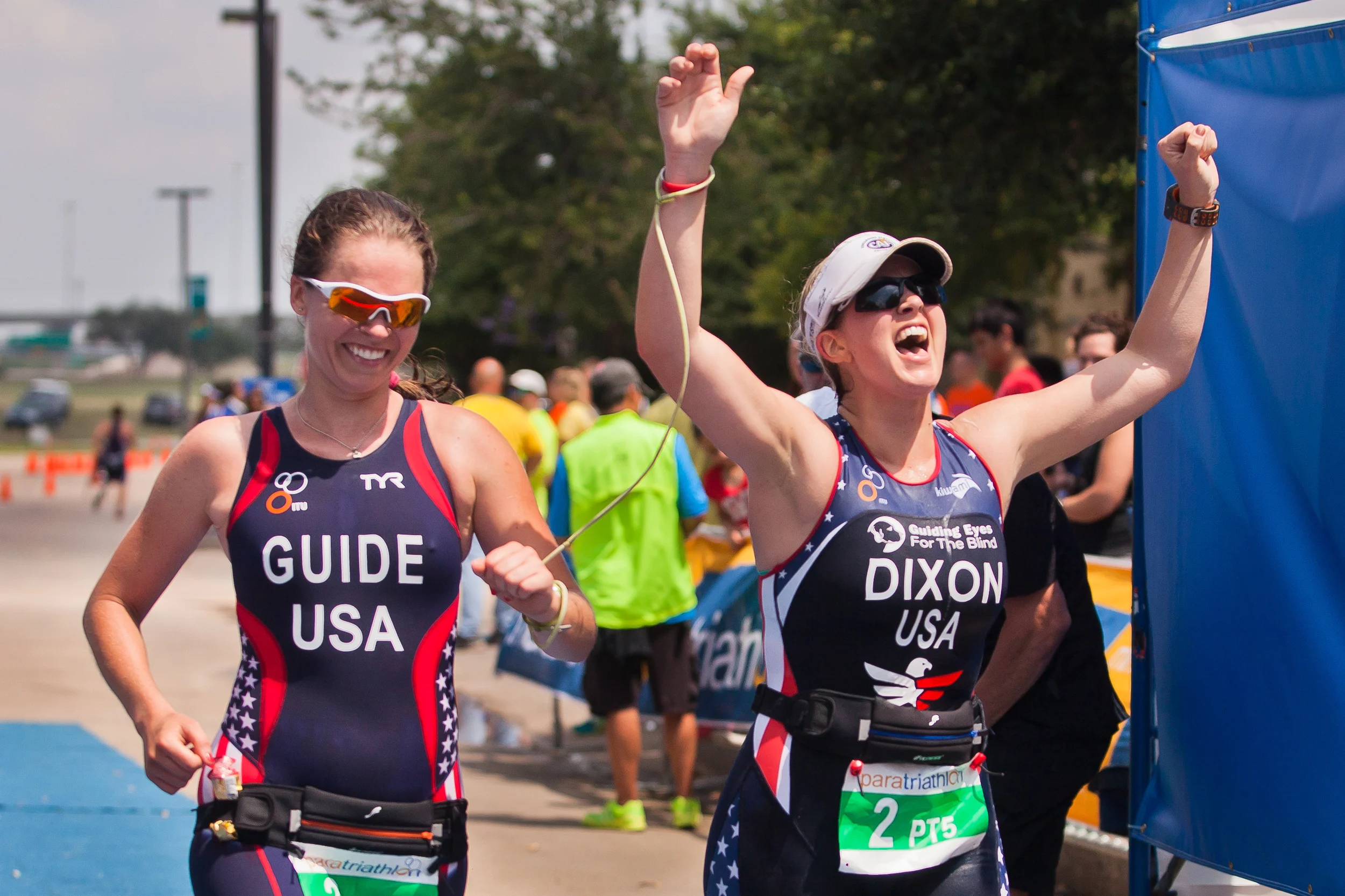  Amy Dixon (right), a visually impaired sommelier and triathlete, crosses the finish line of the 2014 Dallas Panamerican Triathlon Confederation (PATCO) Triathlon Pan American Championships with her guide Caroline Gaynor (left), co-triathlon director