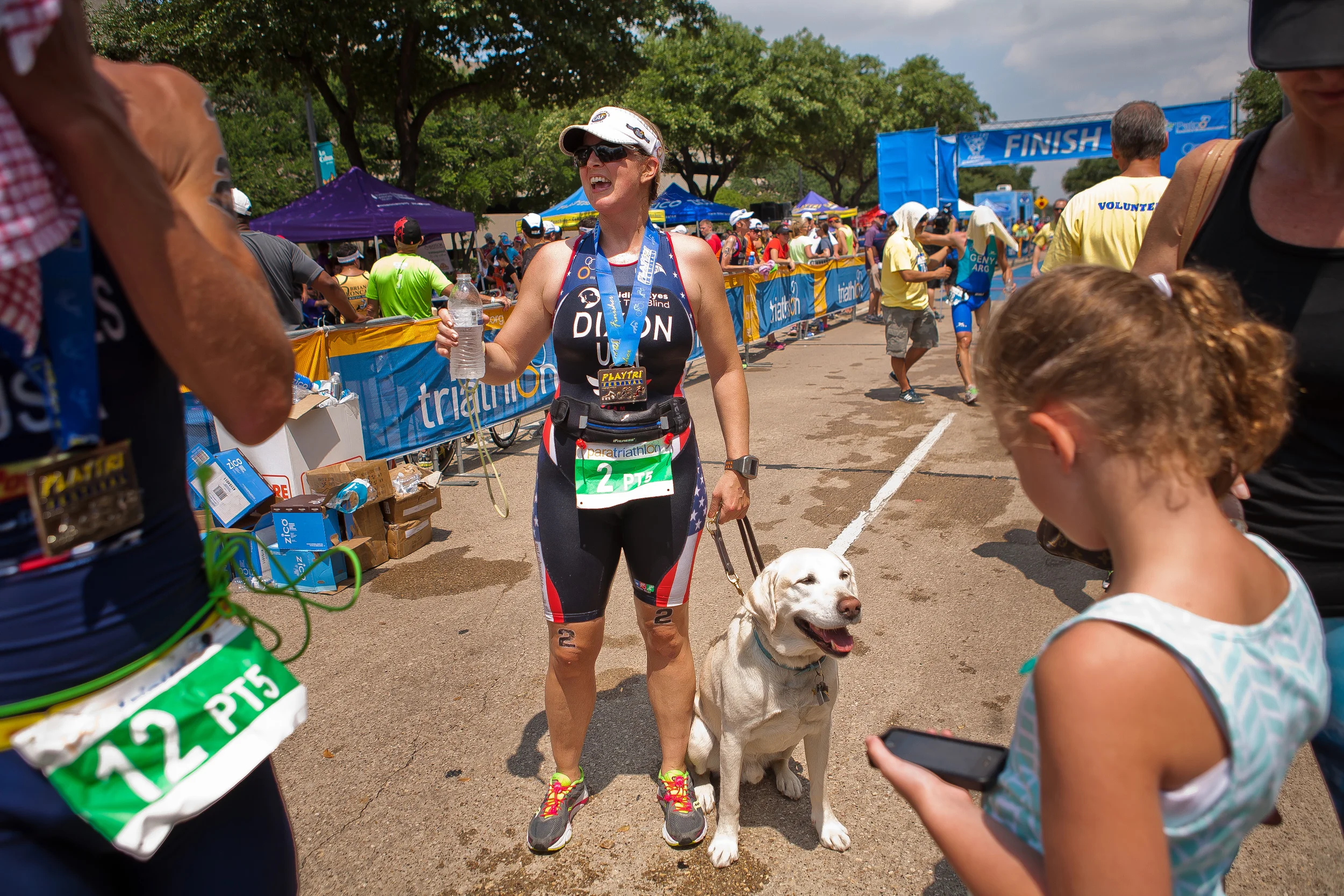  Amy Dixon, a visually impaired sommelier and triathlete, is reunited with her guide dog Elvis after crossing the finish line of the 2014 Dallas Panamerican Triathlon Confederation (PATCO) Triathlon Pan American Championships on June 1, 2014 at the M