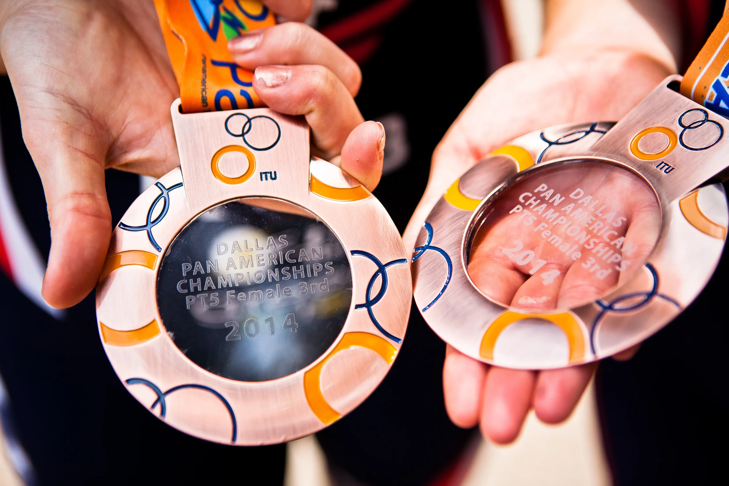  Amy Dixon (left), a visually impaired sommelier and triathlete, and her guide Caroline Gaynor (left), co-triathlon director at Team Red, White & Blue, pose after winning third place in Dixon's division of the 2014 Dallas Panamerican Triathlon Confed