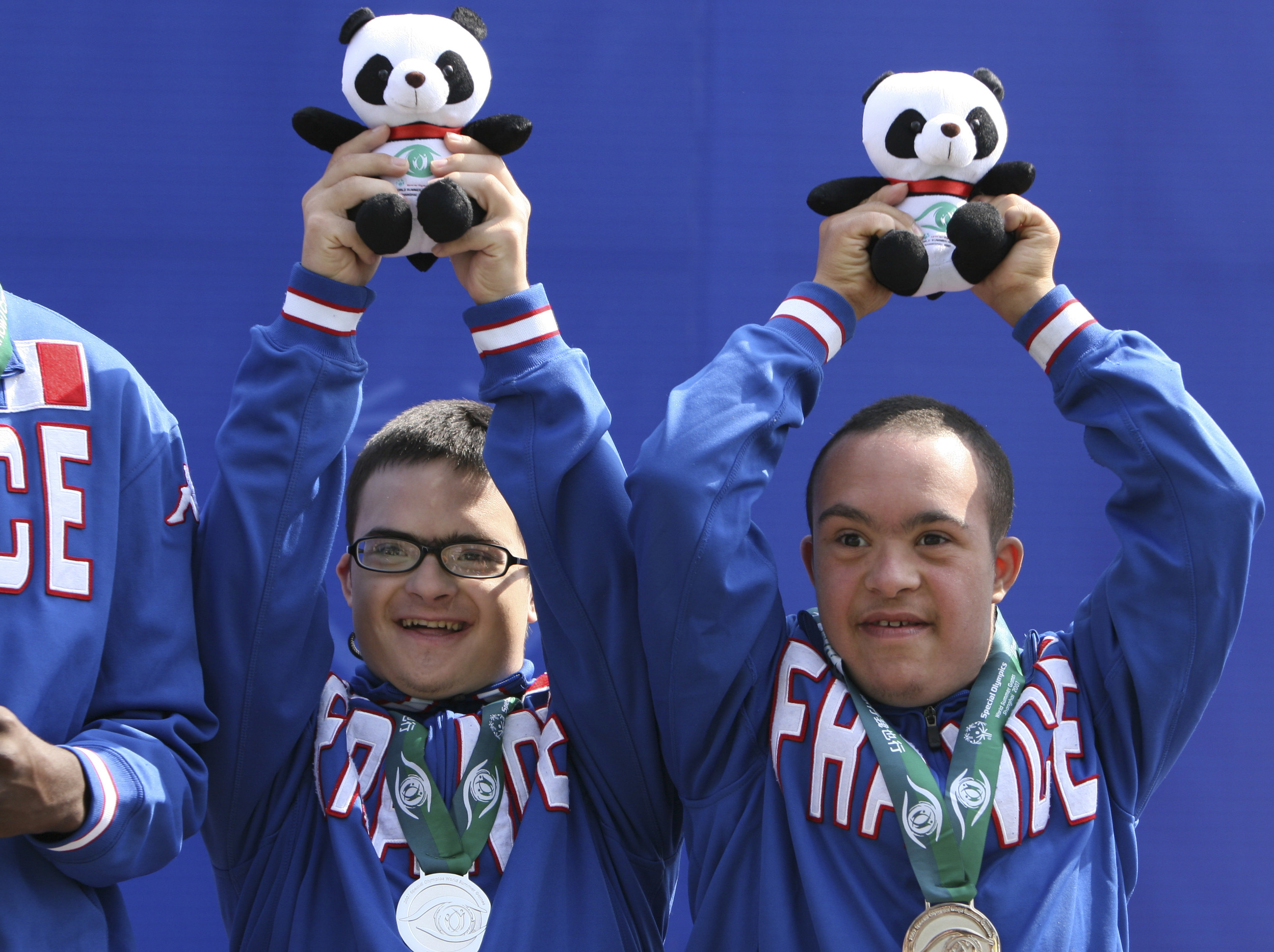Thomas Alves, 15, and Khalid Elhamdi, 18, celebrate their silver medals for men’s 11-a-side football at the award ceremony at Shanghai Songjiang Stadium. 