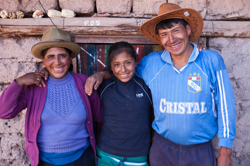  Mariela poses with her parents outside their home. She lives more than a five hour walk from the closest secondary school; without Sacred Valley Project's dormitory, she would not be able to attend. 