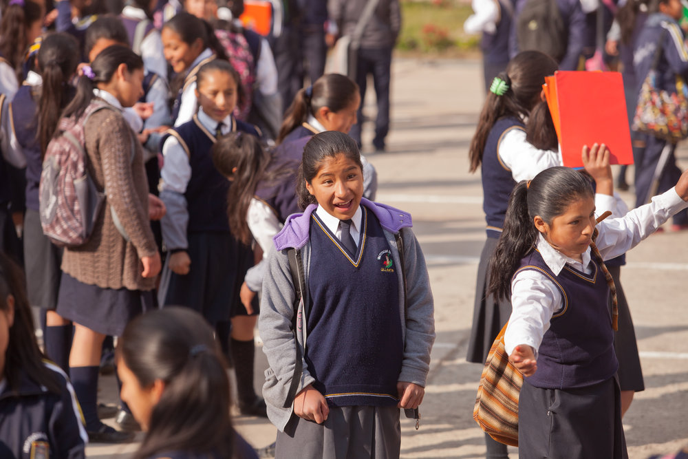  7:45am: Eliabeth gathers with classmates in the courtyard before school begins. The school gathers in lines for morning announcements before heading to class.  