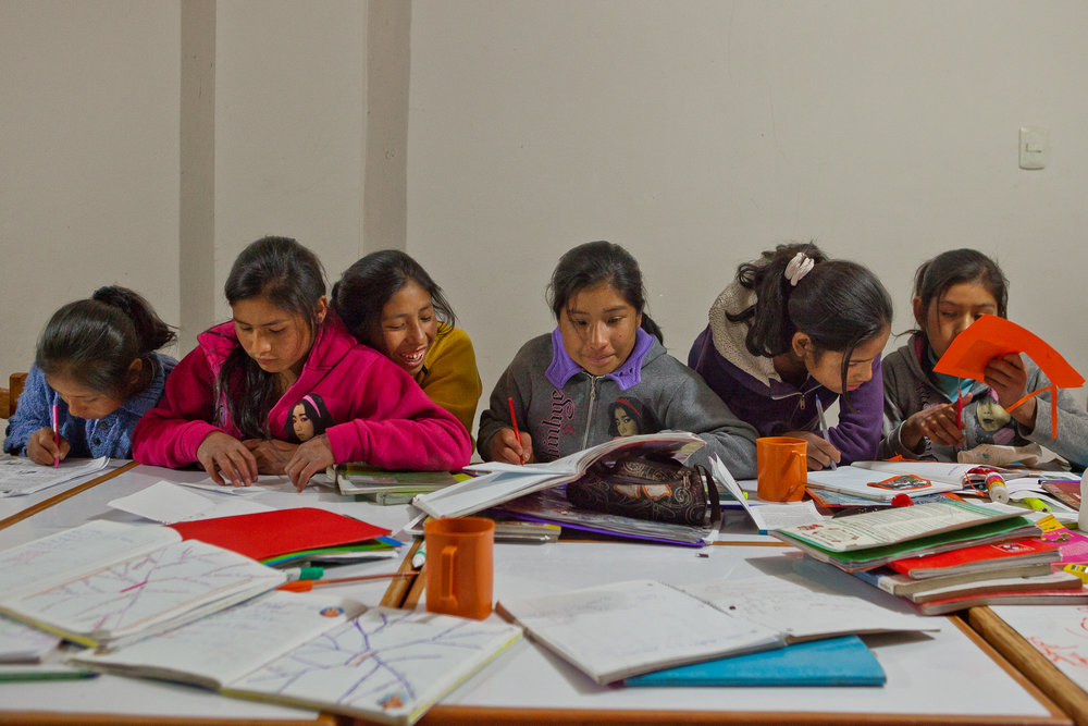  After school each day, the girls gather to work on their homework together. From left, Mariela, Marisol, Nilda, Elizabeth, Nayda, and Flor Nayda work on various homework assignments.  