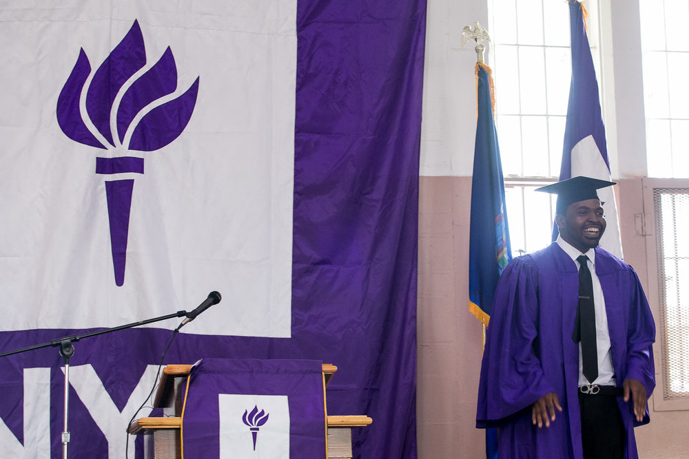  Vincent shows off his suit under his graduation gown. He has been released from Wallkill but came back for graduation, which he said was difficult, but he was glad that he did. He's working with program staff to continue his education at NYU's main 