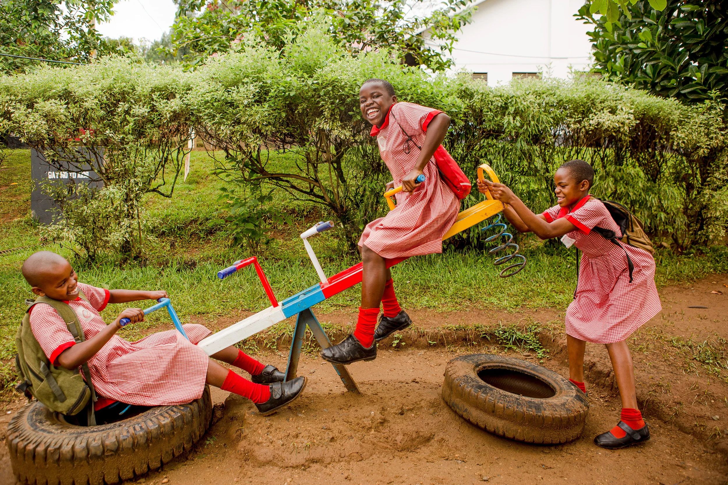  Joy, Susan, and Robinah play on the playground. 