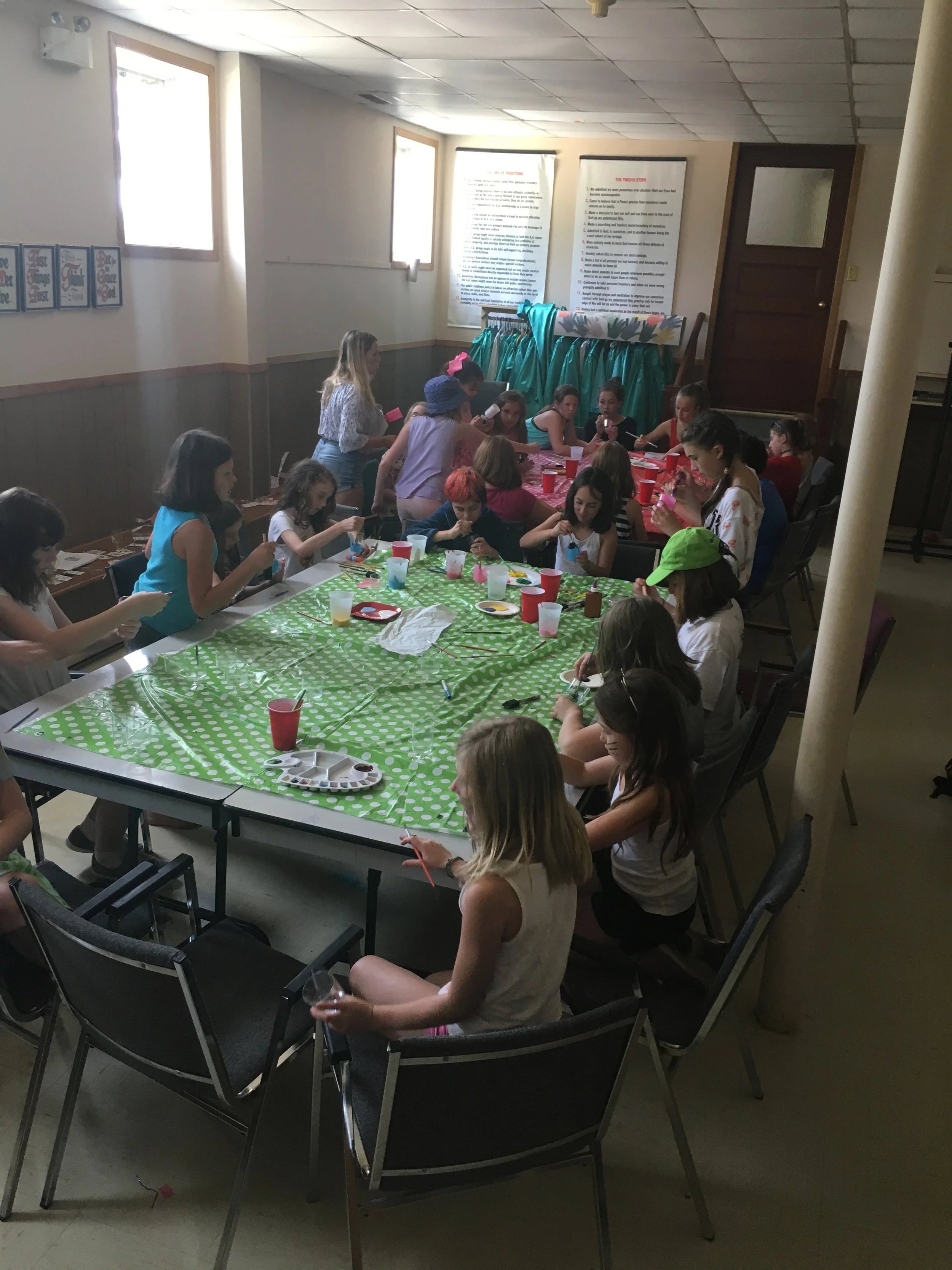 The campers painting the tea cups for the tea part scene in Alice In Wonderland Photo Credits: Holly Lohnes