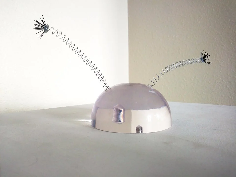  the existential anxiety of a virtual particle  lucite, metal springs, nylon 