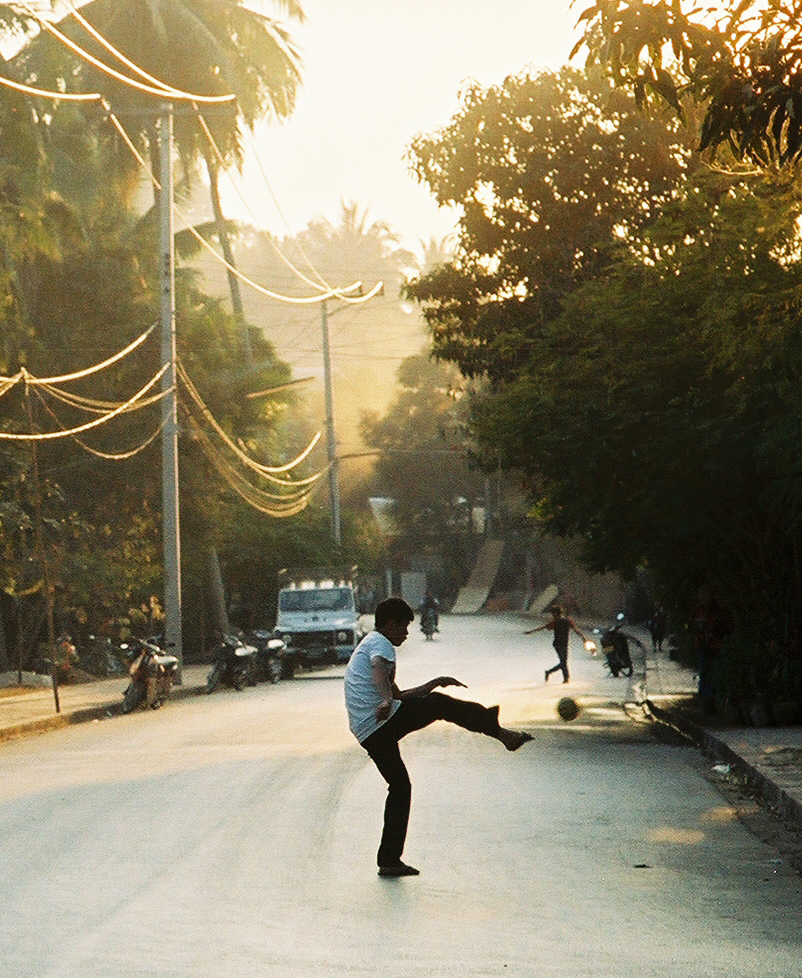 Laos_Boy_Kicking_Ball.jpg