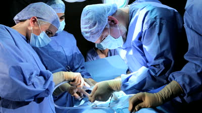 stock-footage-male-female-surgical-team-in-protective-clothing-performing-surgery-hospital-operating-theatre.jpg