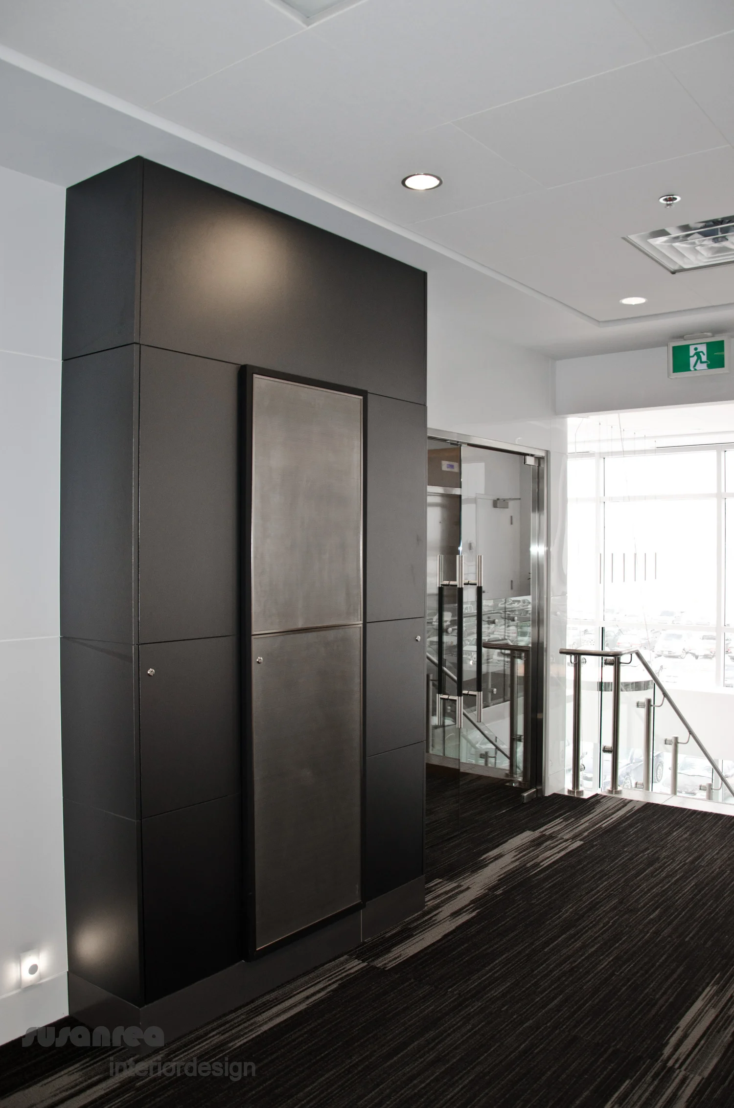 Dark metallic mill-work panels contrast dramatically with the shiny metals and translucent white walls.Subtle disc shaped details throughout.Ventilated access for the AV equipment is in the corridor so as not to interrupt sessions in the conference room. Carpet by Shaw Contract