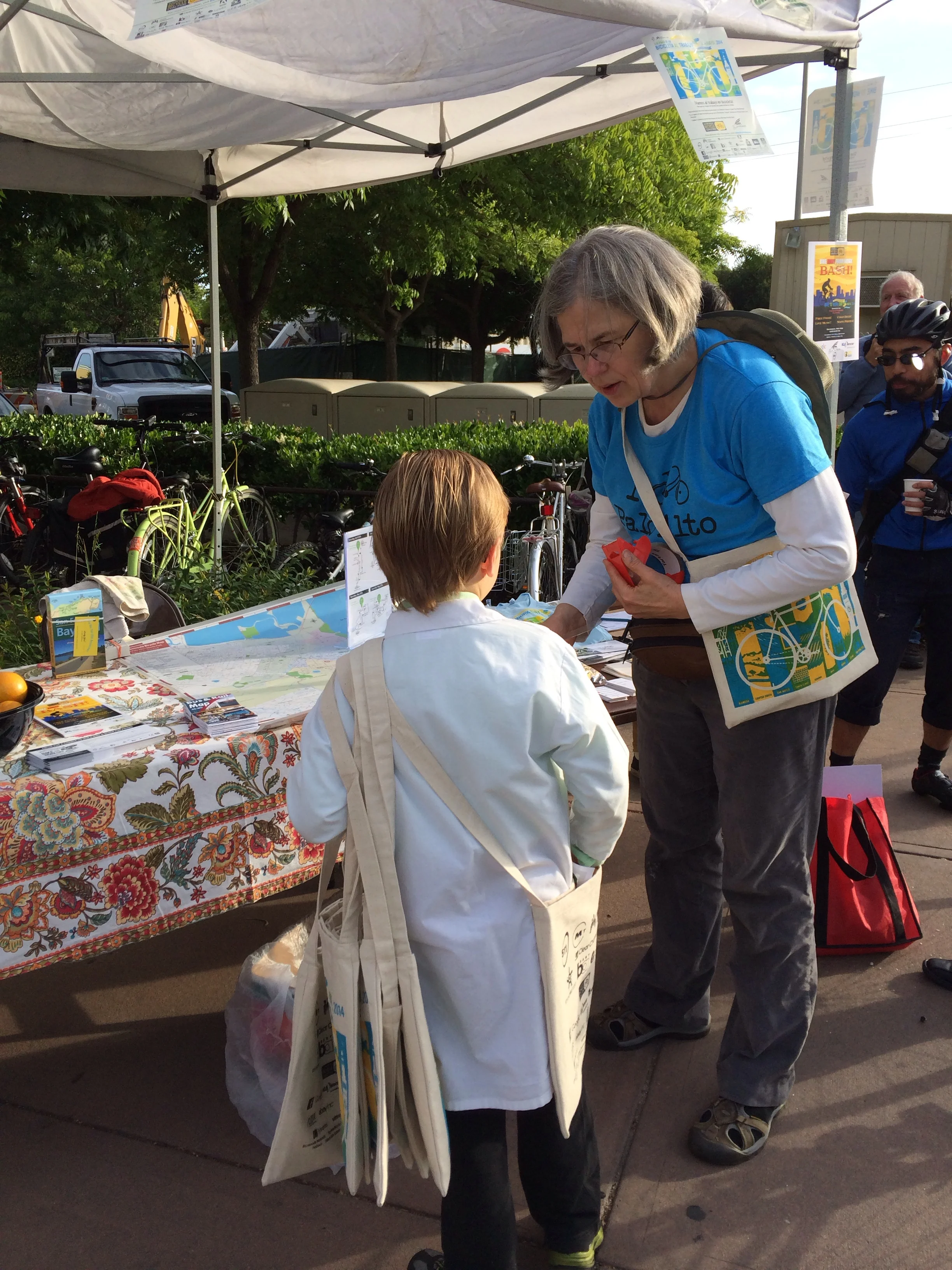 Kathy Durham, Palo Alto's Safe Routes to School/Commute coordinator, gives Elliot goodie bags to hand out.