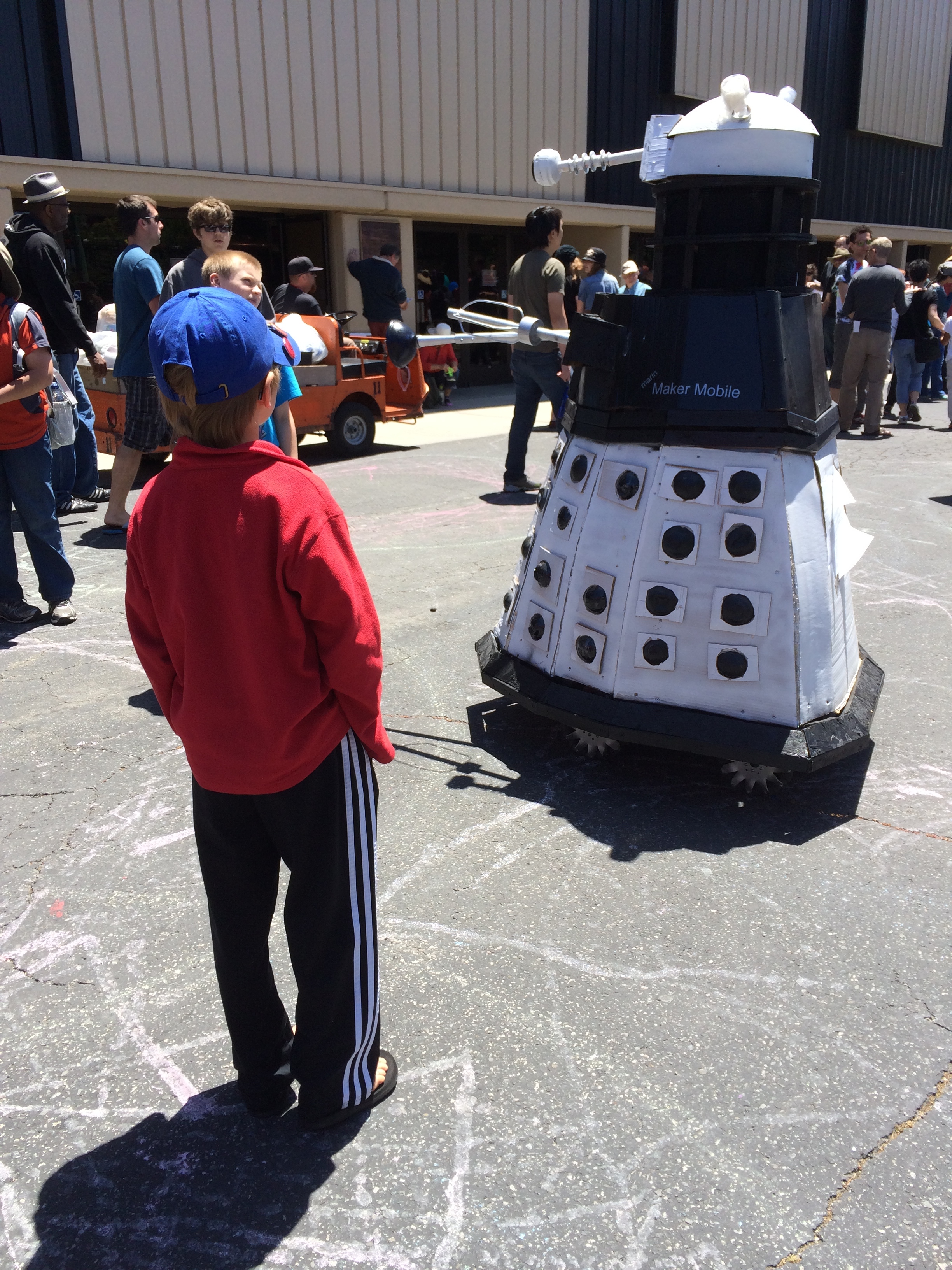 Elliot meets a random wandering robot at Maker Faire 2014.