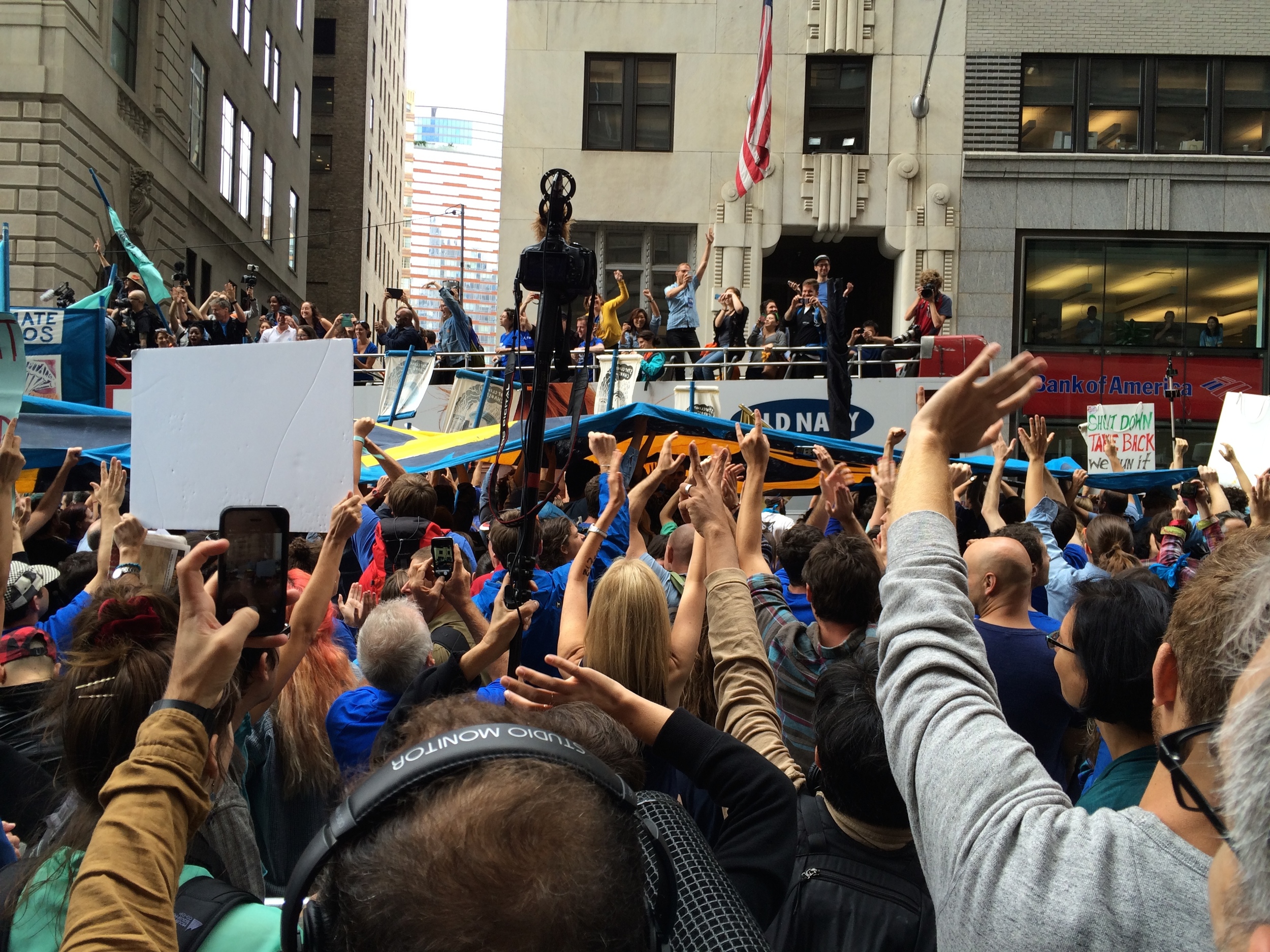 Flood Wall Street protestors commandeer a tourist bus - to the delight of everyone inside the barricades