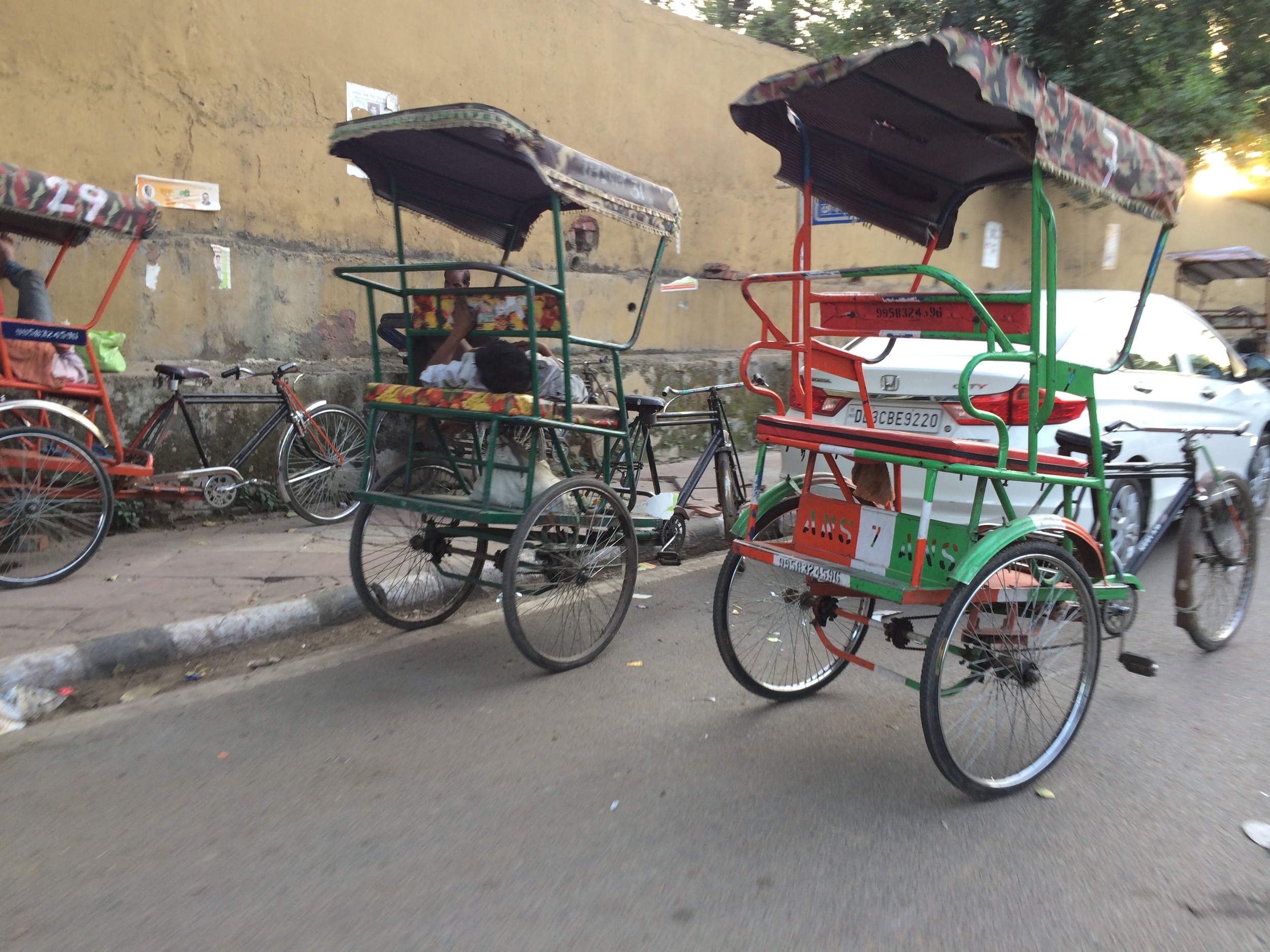 Bicycle rickshaw driver napping in New Delhi