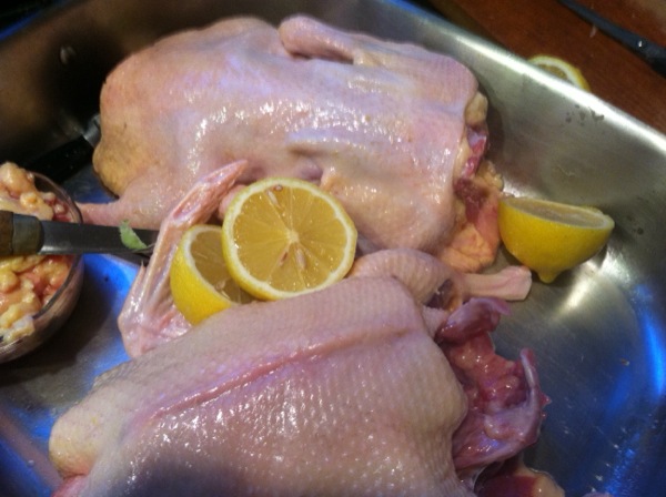 Rub with lemon and salt. Place the lemon and a trimmed garlic head in the body cavity.