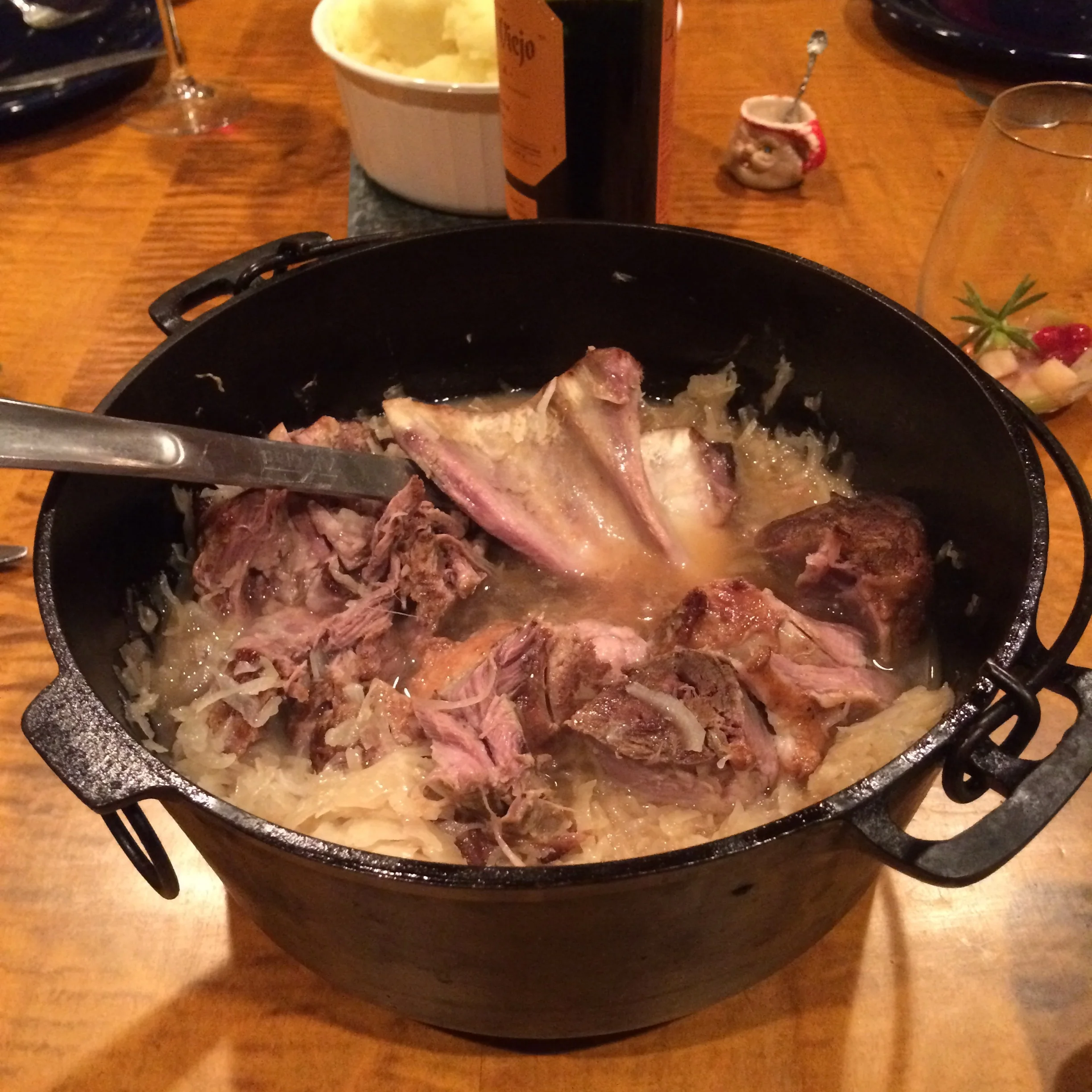 After browning, I covered the pot and put it into a 250' oven for about 2 hours; added the sauerkraut and covered the pot for another hour and a half; and pulled apart the meat for serving.