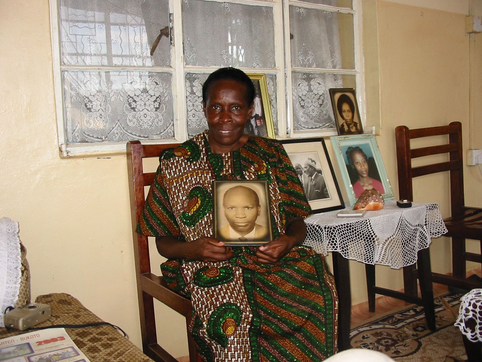 Joyce Laki with her father's portrait (Andrew Rice)