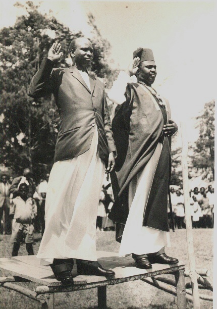  Eliphaz Laki (left) and James Kahigiriza stand together at Laki's swearing-in as a chief, circa 1963. (Laki family)  