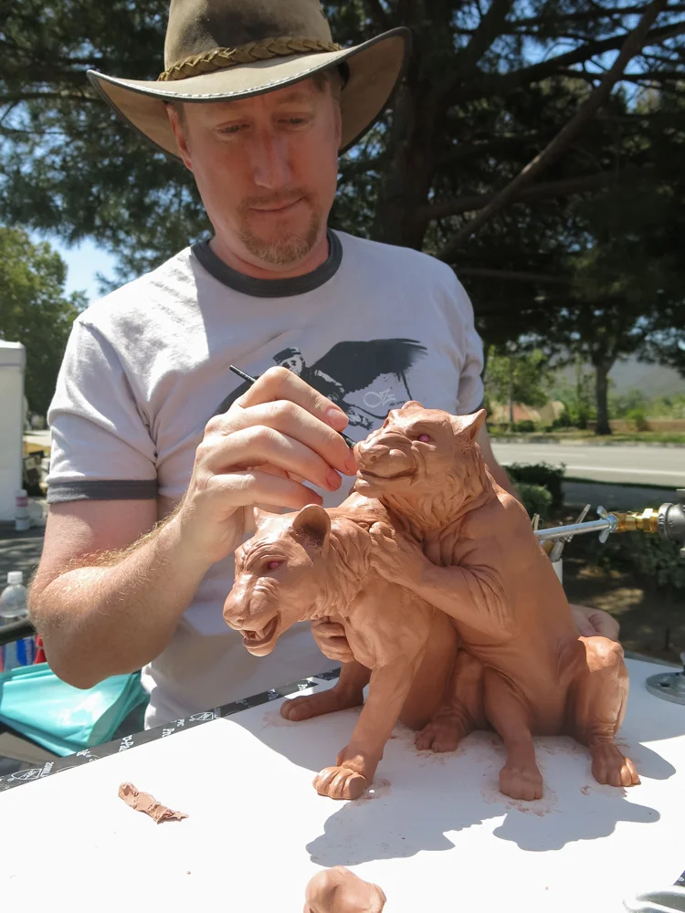 Terrence puts some finishing touches on his latest work, "Little Rascals" at the Thousand Oaks ArtWalk 2014