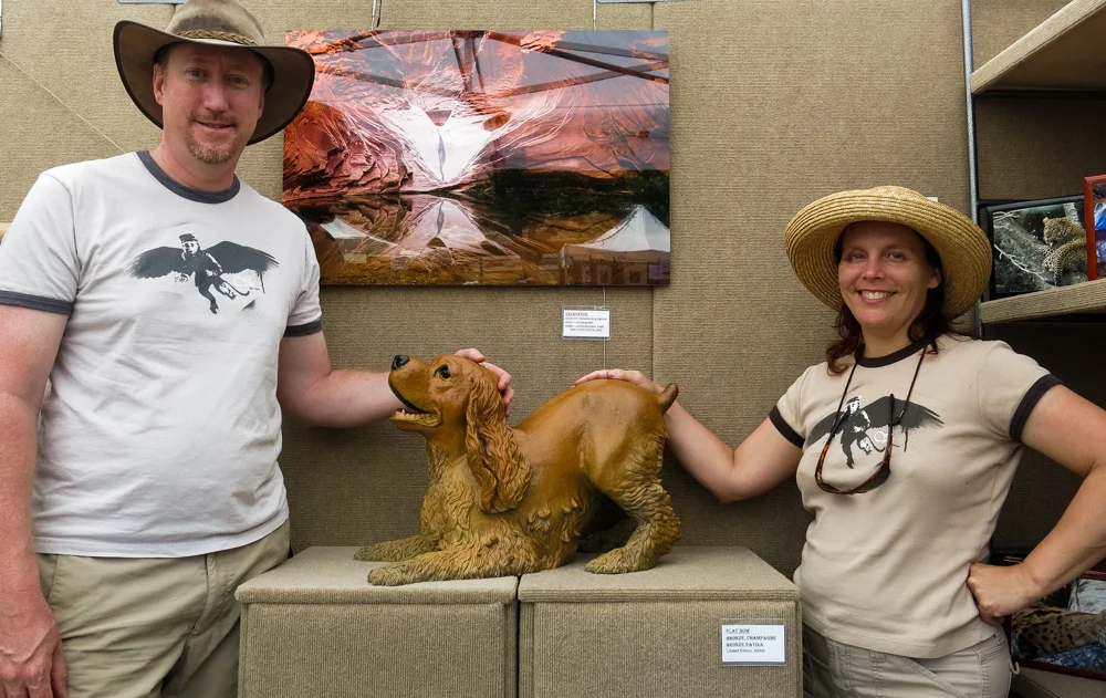 Terrence and Karen Robertson-Fall stand next to Play Bow finished in a reddish patina.
