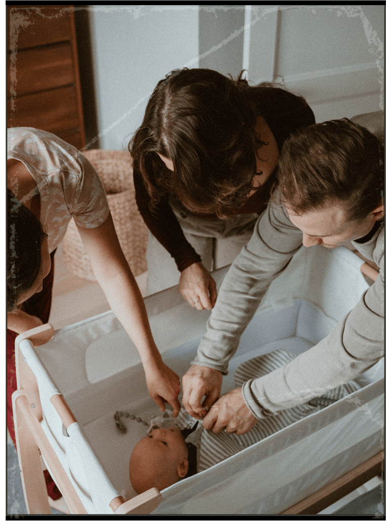 Julia-Rose Scianna provides sleep consulting services to new parents in Mt. Hood, while cooing at their baby in the crib.