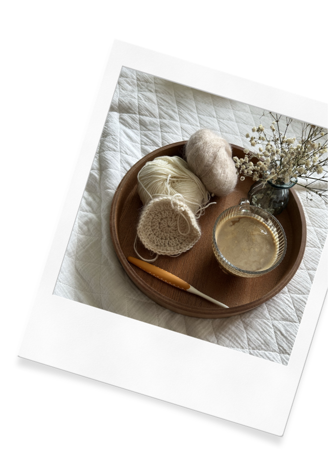 A crochet project sitting on a tray on the Wildflower Doula Services website.